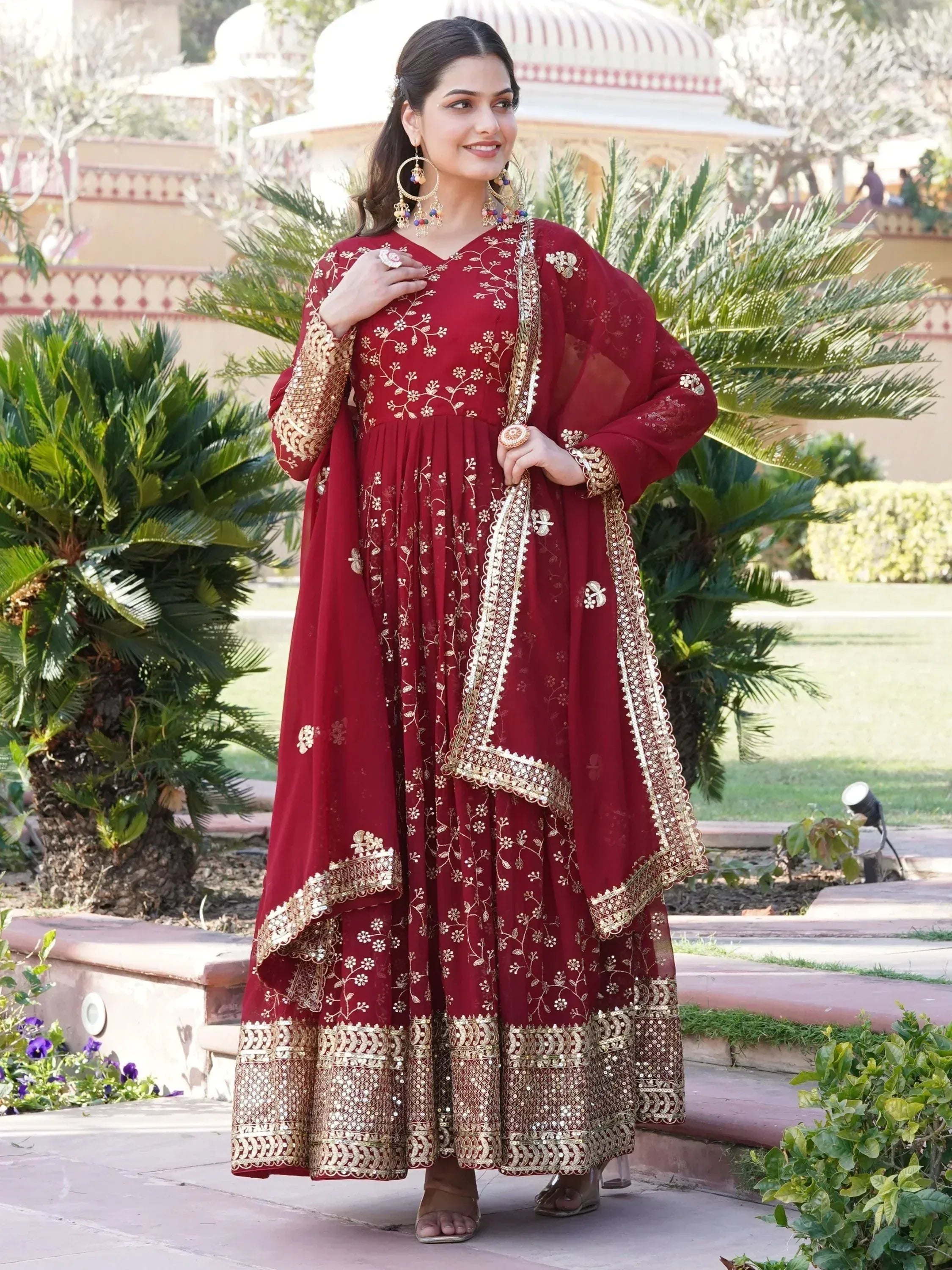 Maroon ethnic gown with gold embroidery, perfect for Indian weddings and festive occasions