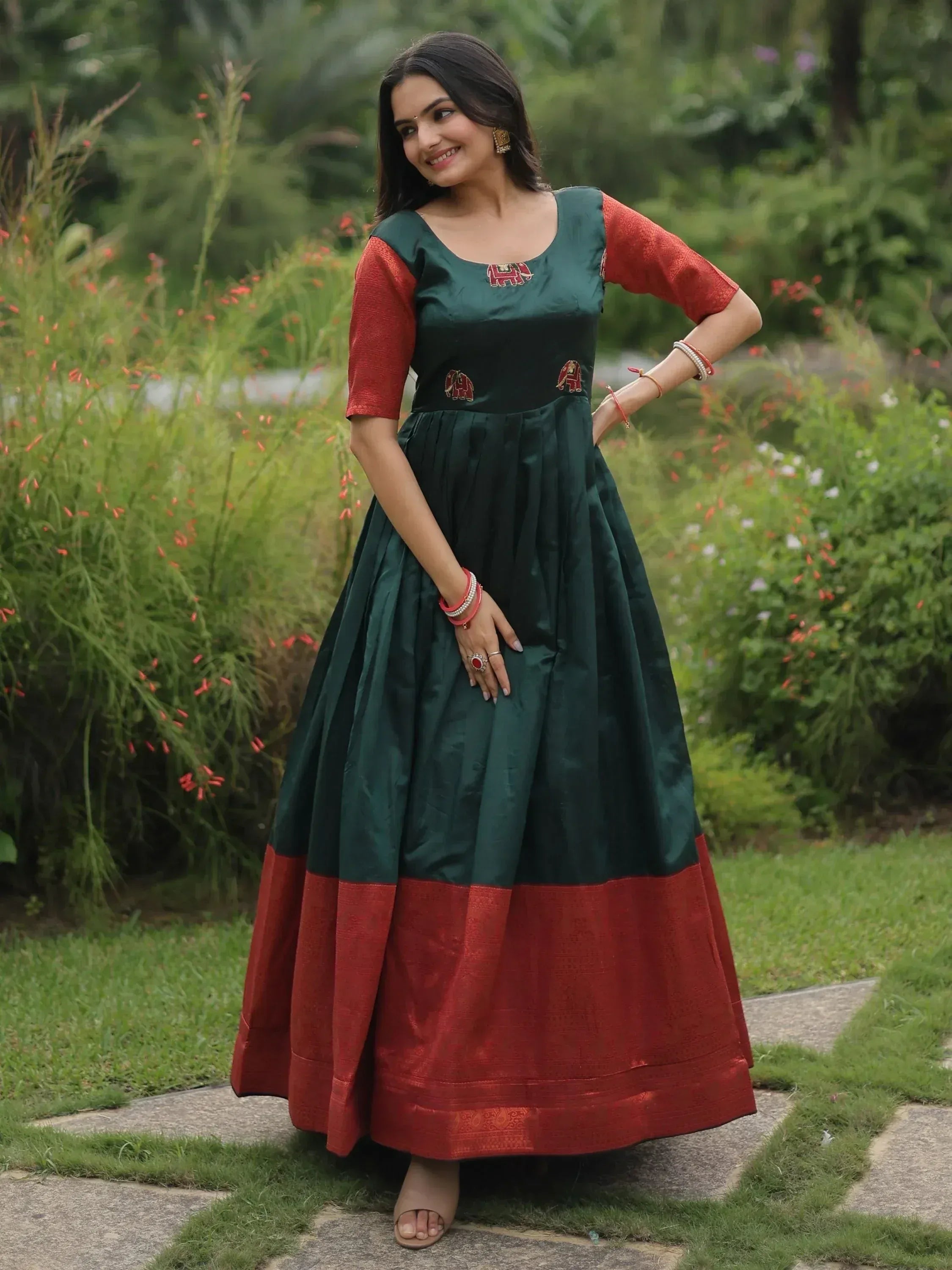 Green and red ethnic gown with elephant embroidery, perfect for Indian festive occasions
