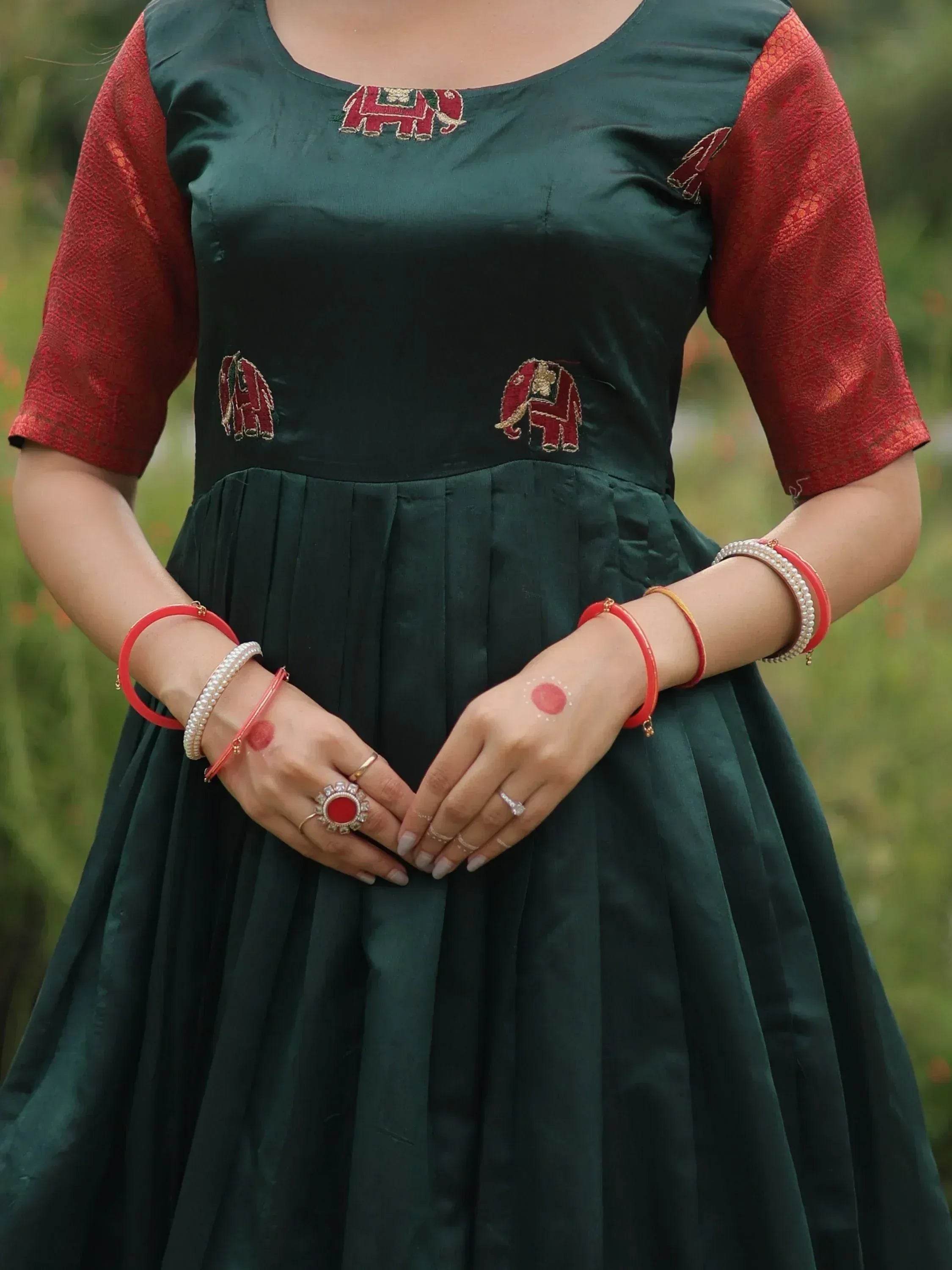 Green ethnic gown with red elephant embroidery and matching bangles