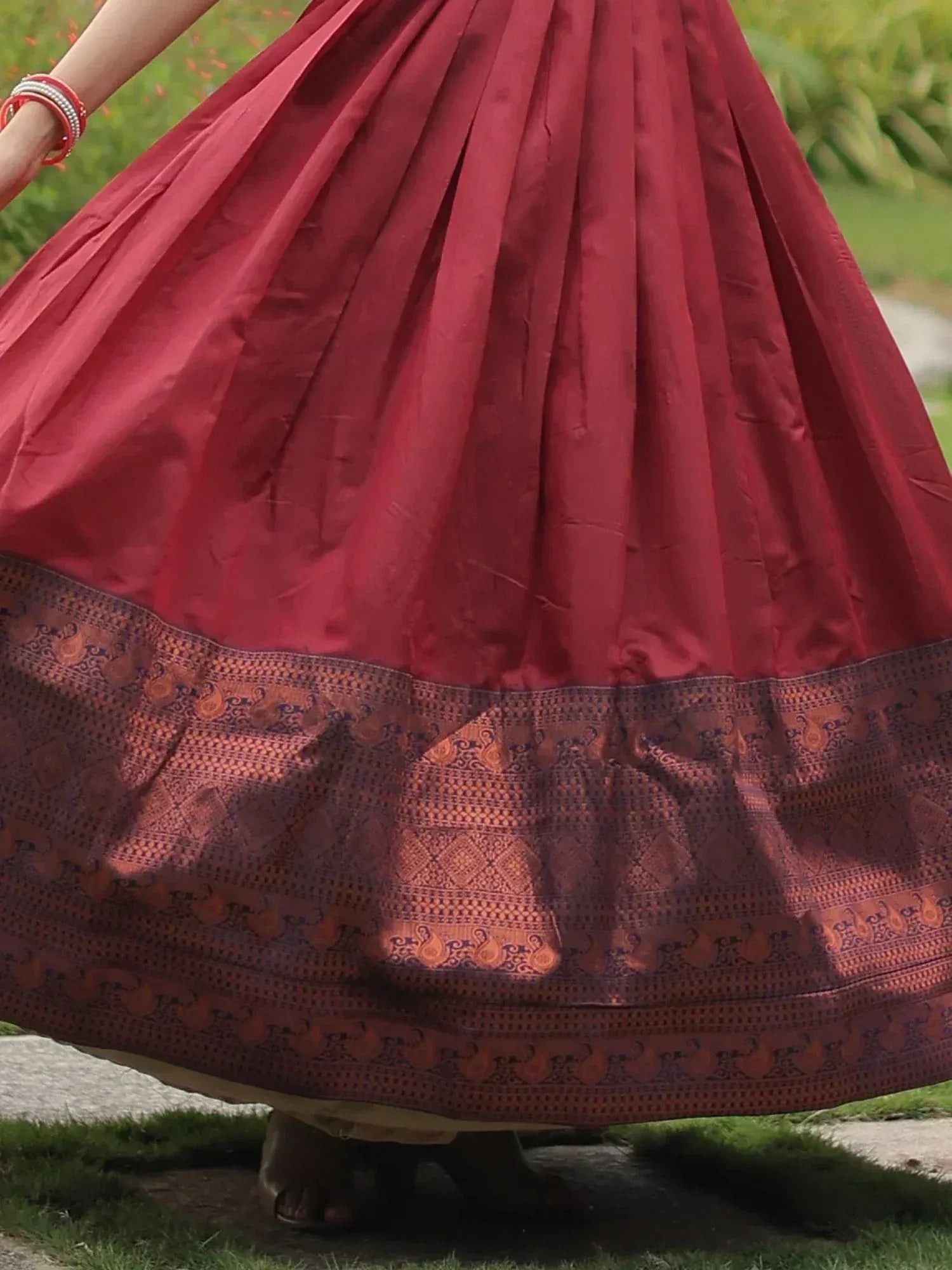 Rich maroon pleated lehenga with intricate border, perfect for Indian ethnic wear occasions