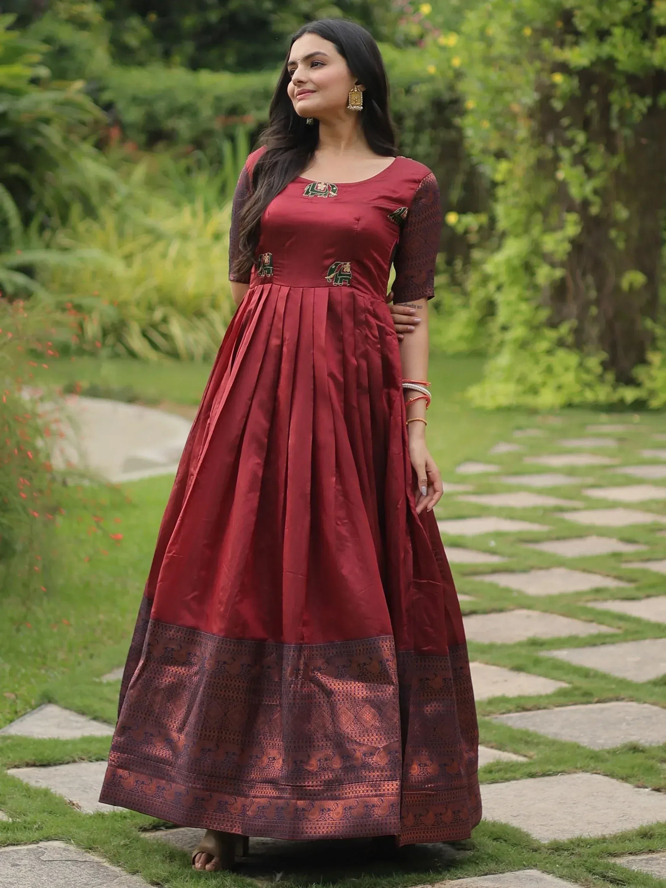 Maroon ethnic gown with elephant embroidery, perfect for Indian occasions and festive wear.