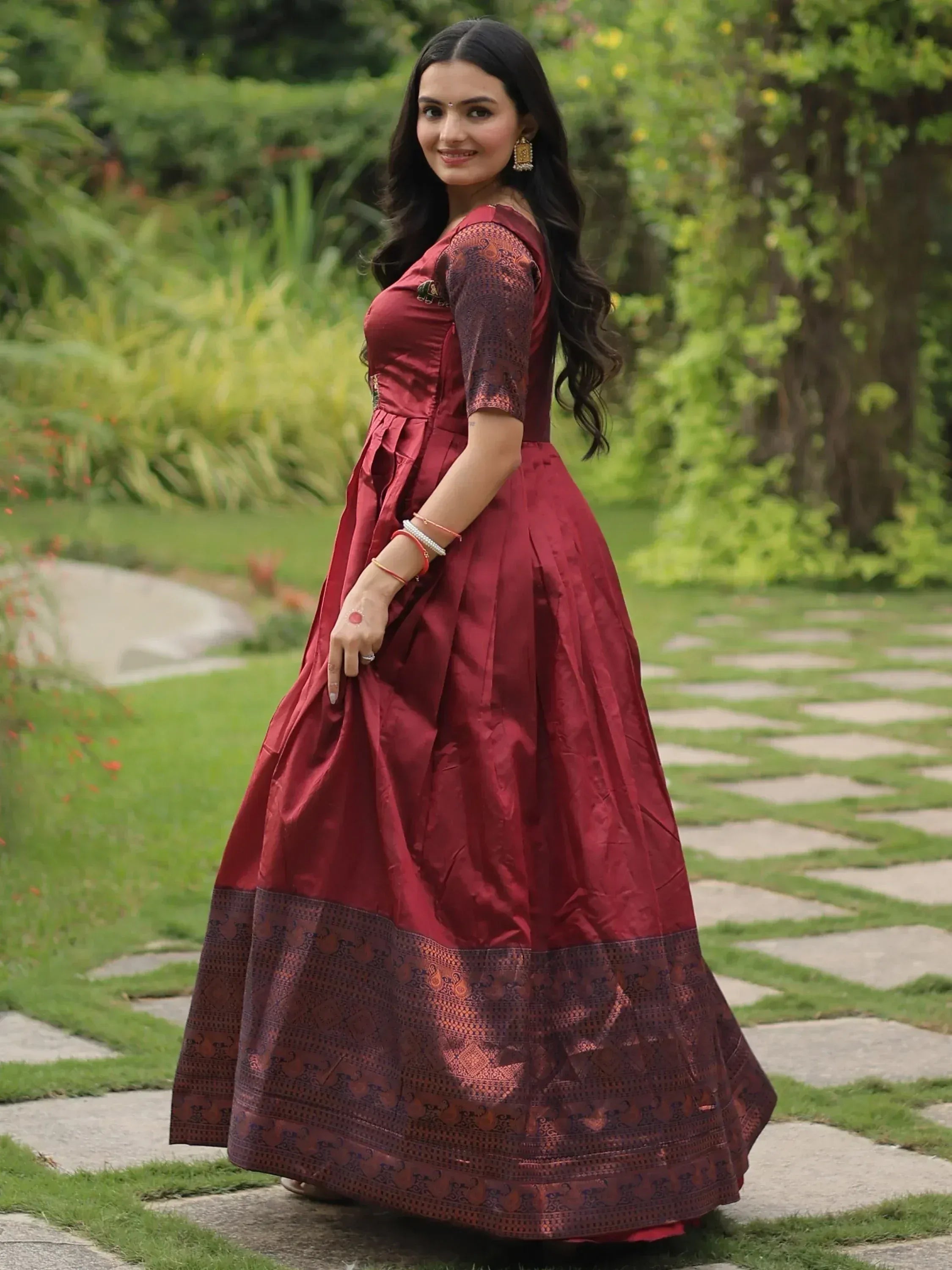 Maroon ethnic gown with intricate border, perfect for Indian occasions and festive wear