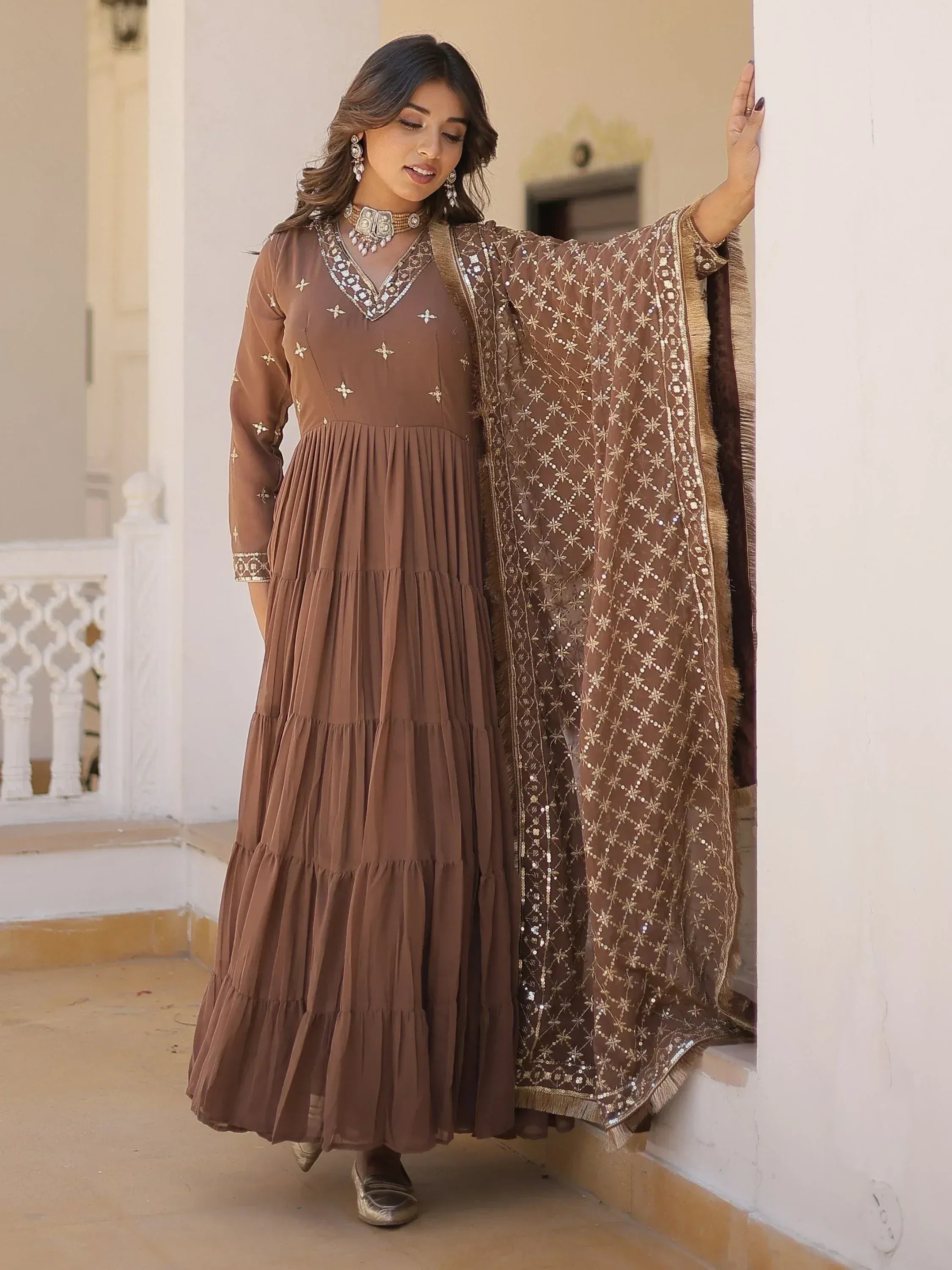 Brown ethnic gown with gold embroidery and matching dupatta, perfect for Indian festive occasions