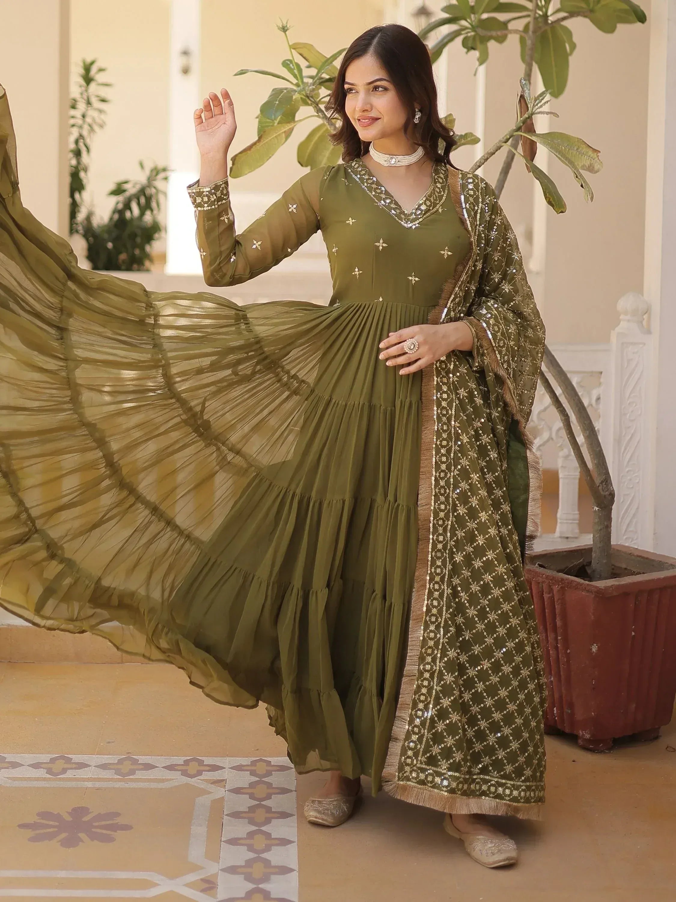 Olive green ethnic gown with gold embroidery, pleated skirt, and matching dupatta for Indian wear