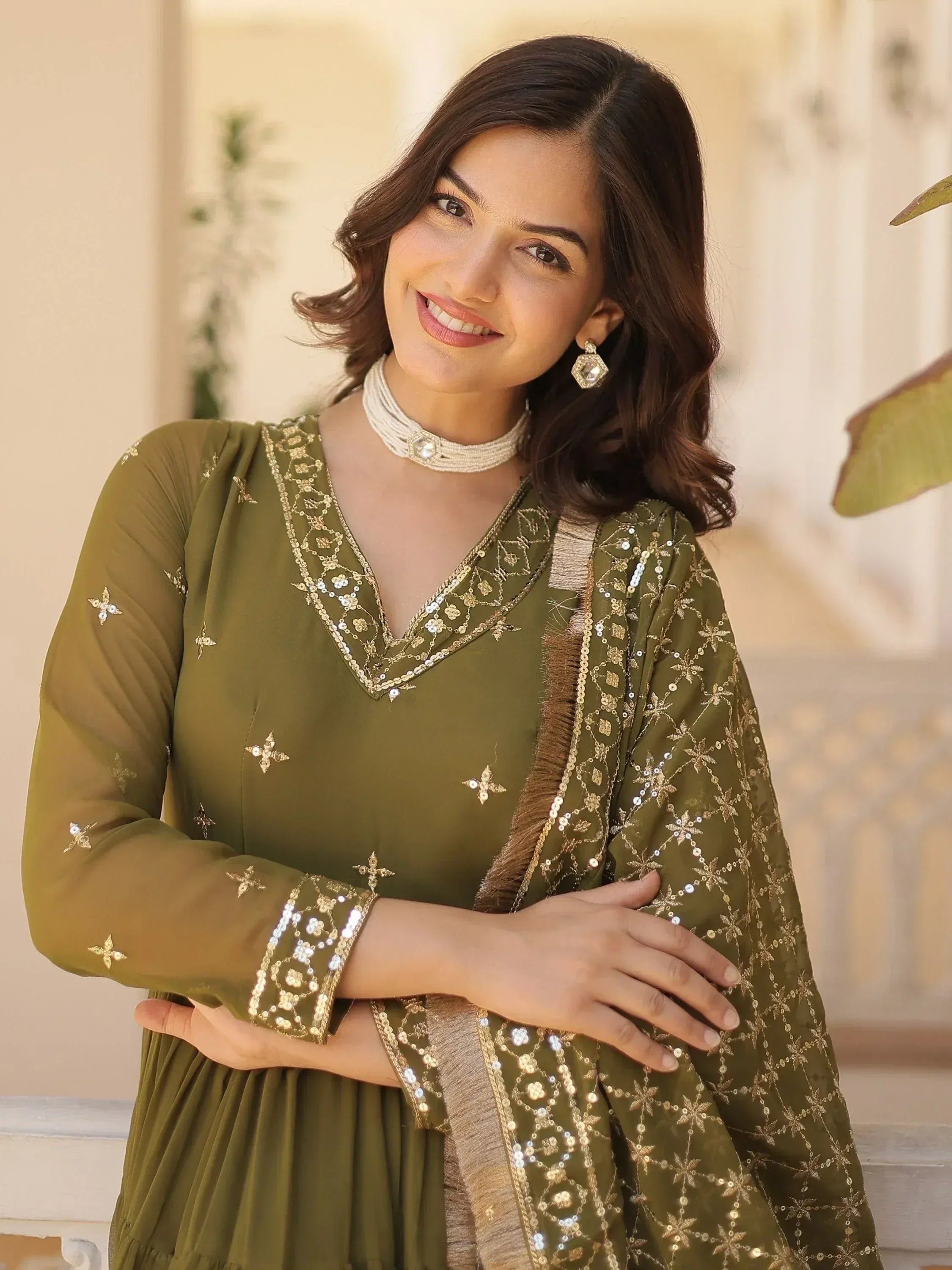 Olive green embroidered salwar kameez with gold sequin work and matching dupatta, perfect for festive occasions.