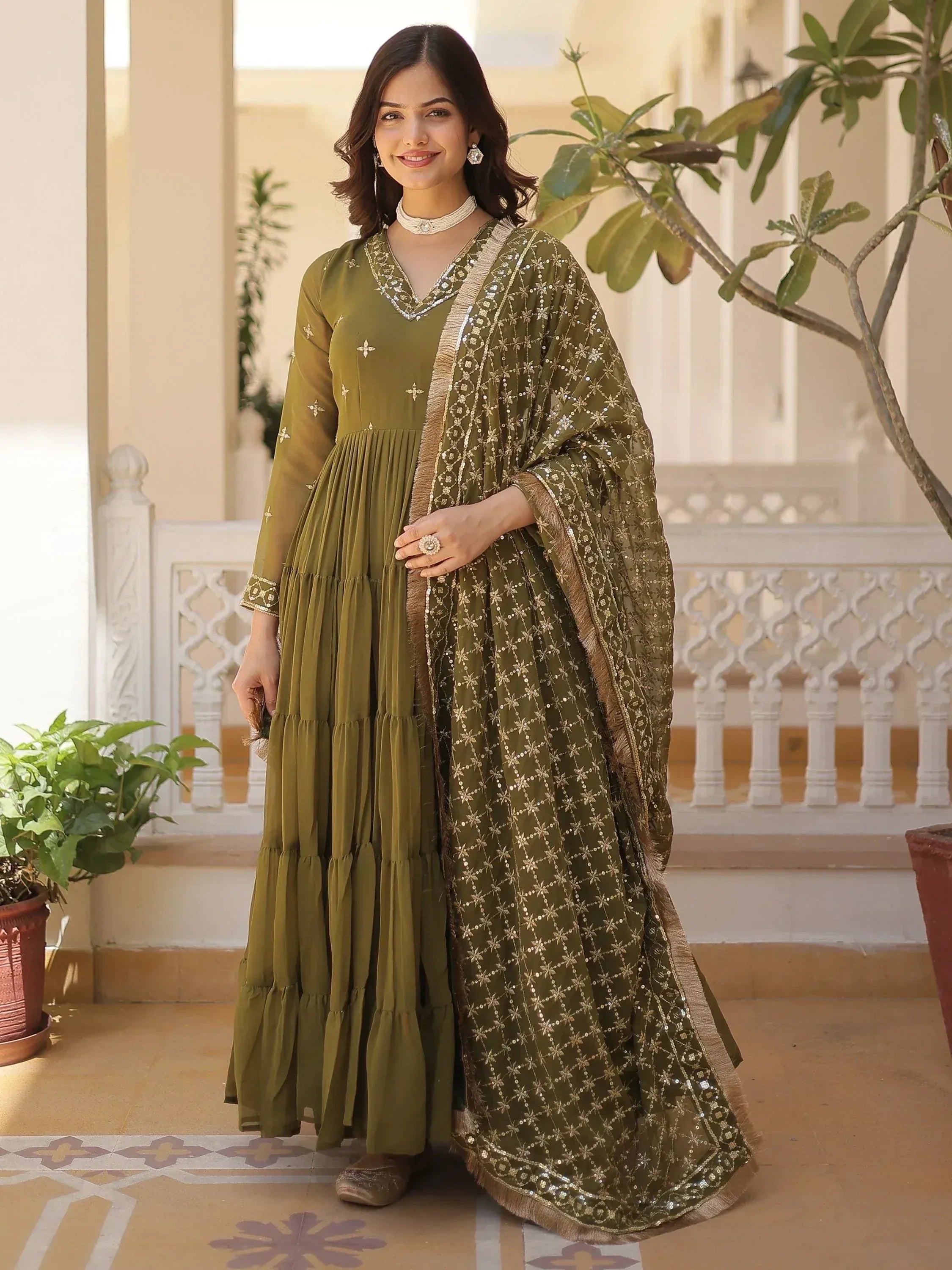 Olive green ethnic gown with gold embroidery and sequin dupatta, perfect for Indian occasions