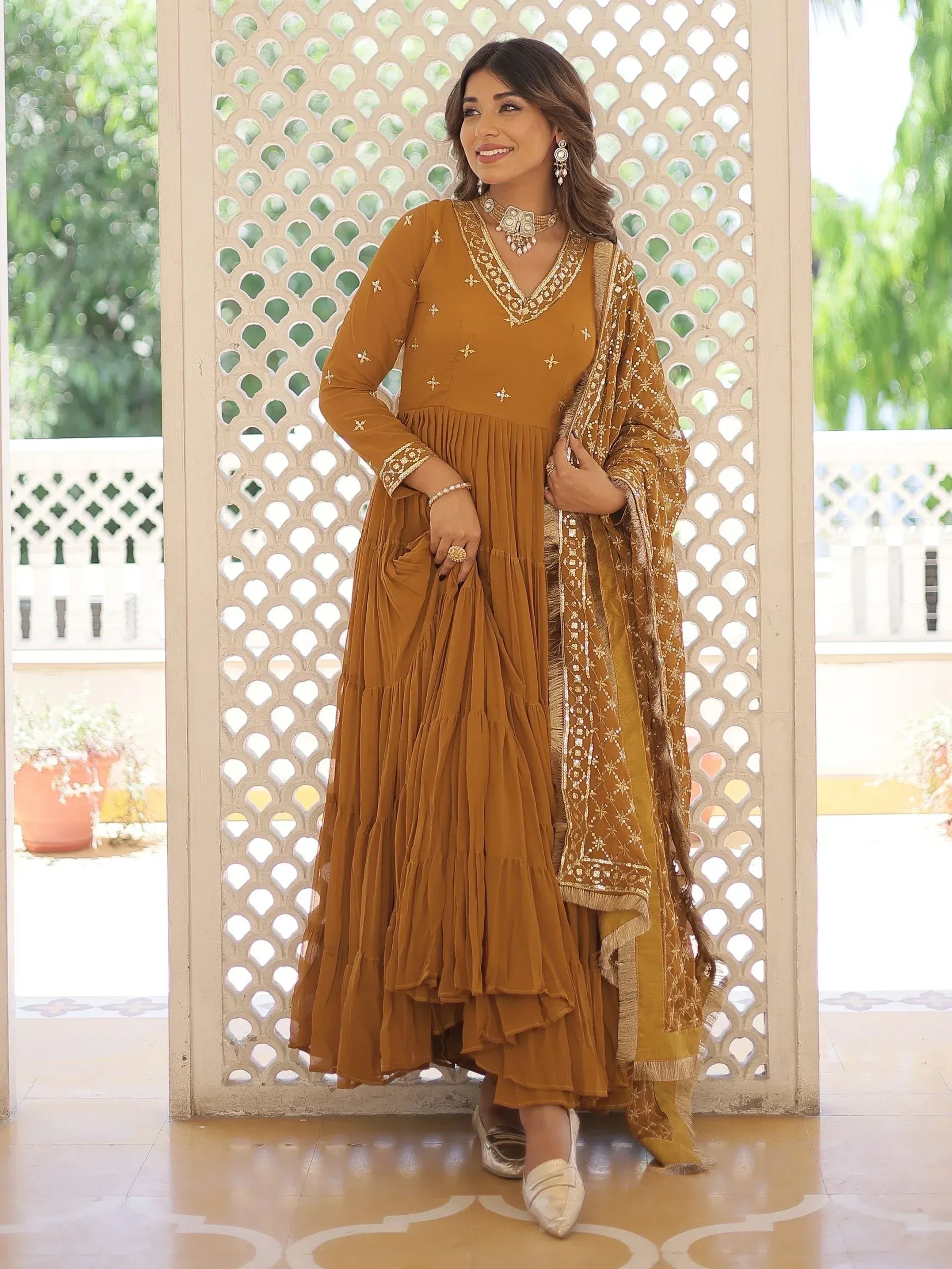 Mustard ethnic gown with gold embroidery, pleated skirt, and matching dupatta for Indian wear
