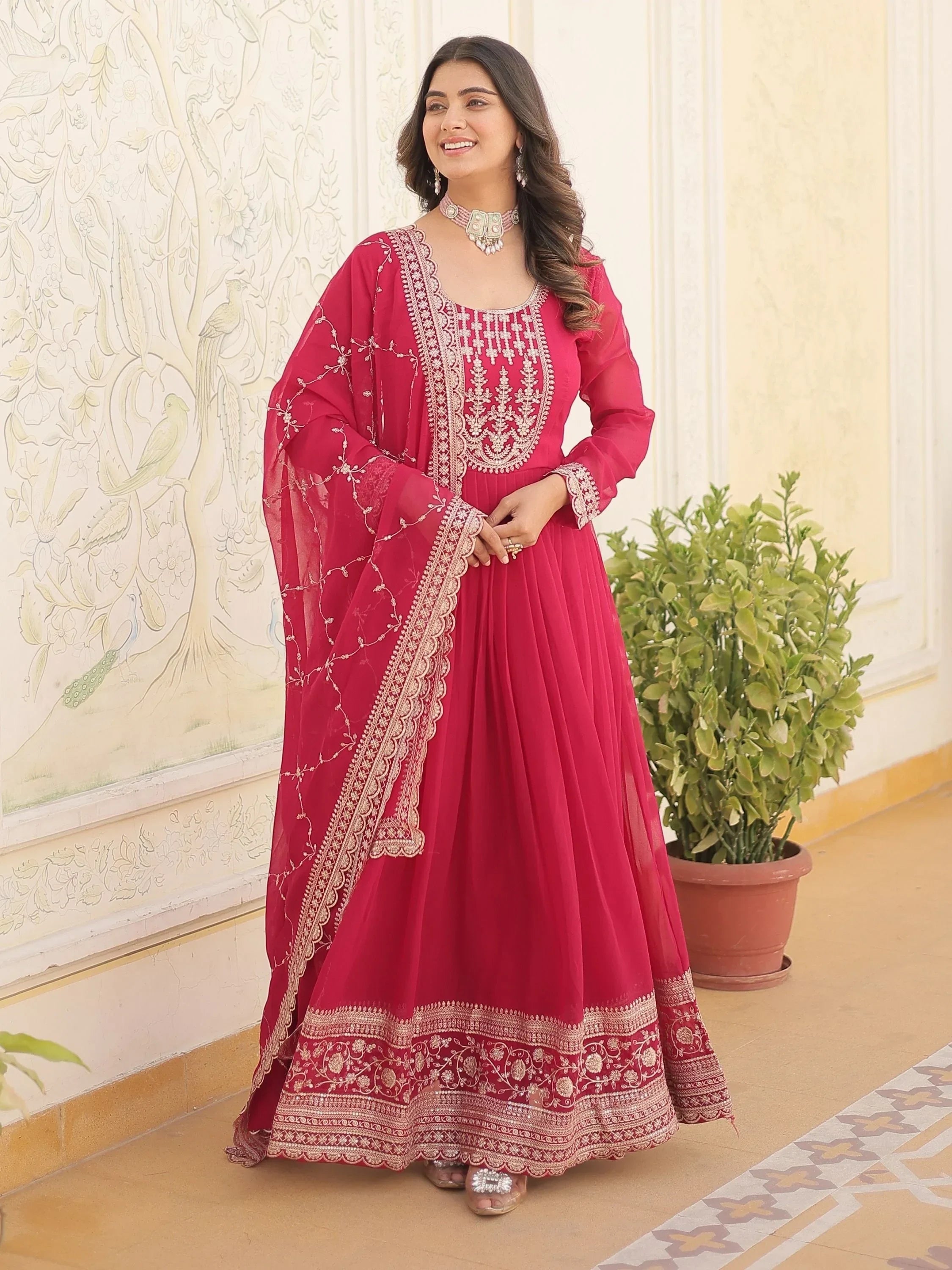 Woman in pink embroidered anarkali suit with dupatta, traditional Indian ethnic wear