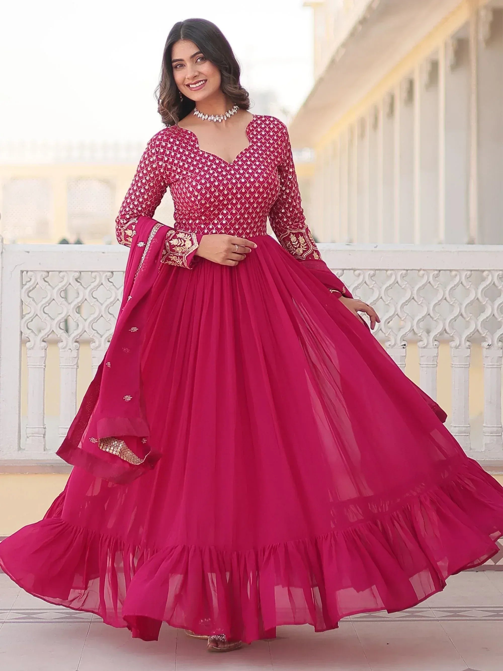 Woman in maroon embroidered lehenga choli with net skirt, perfect for Indian ethnic occasions
