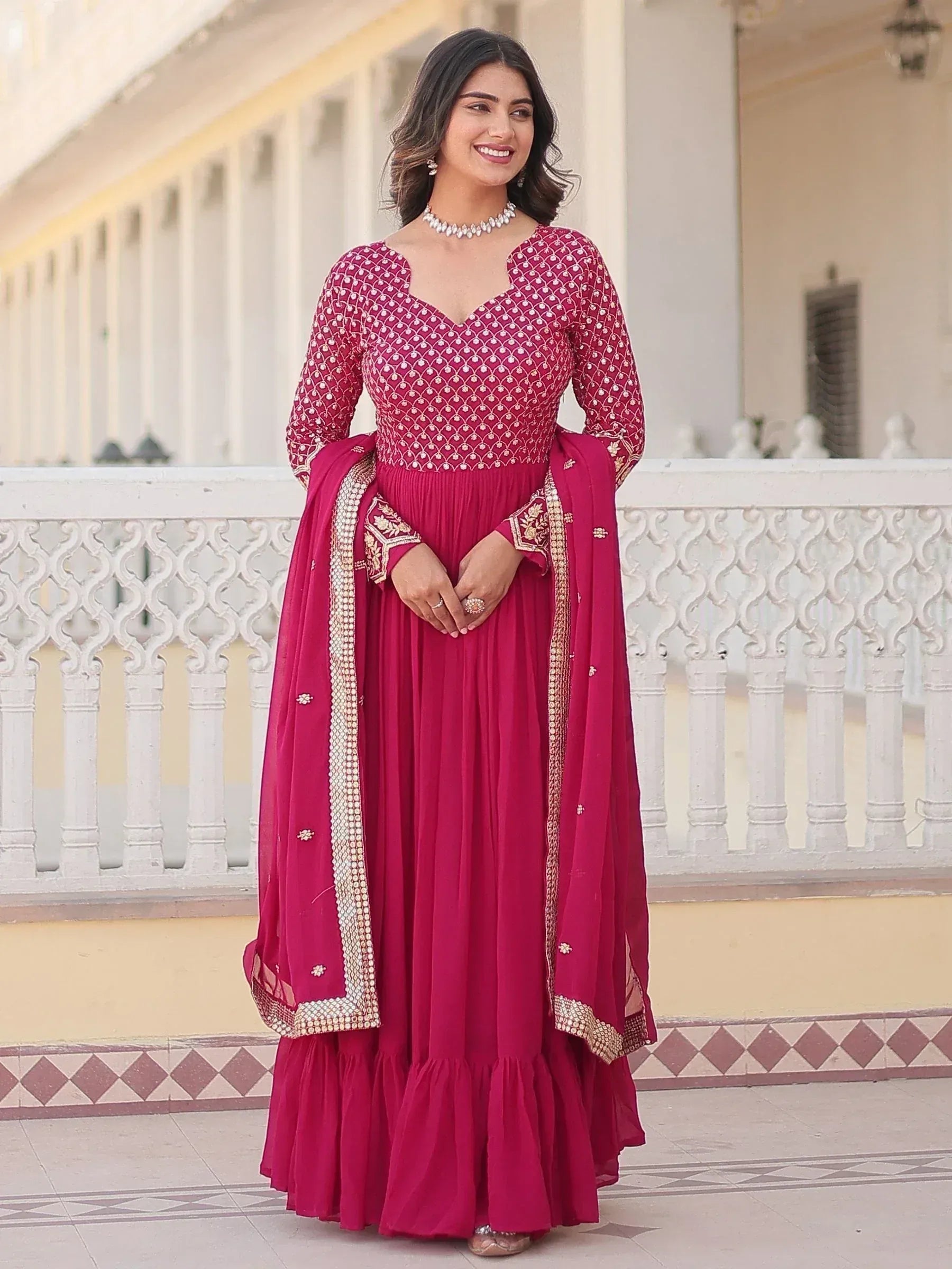Elegant maroon ethnic gown with gold embroidery, perfect for Indian weddings and festive occasions.