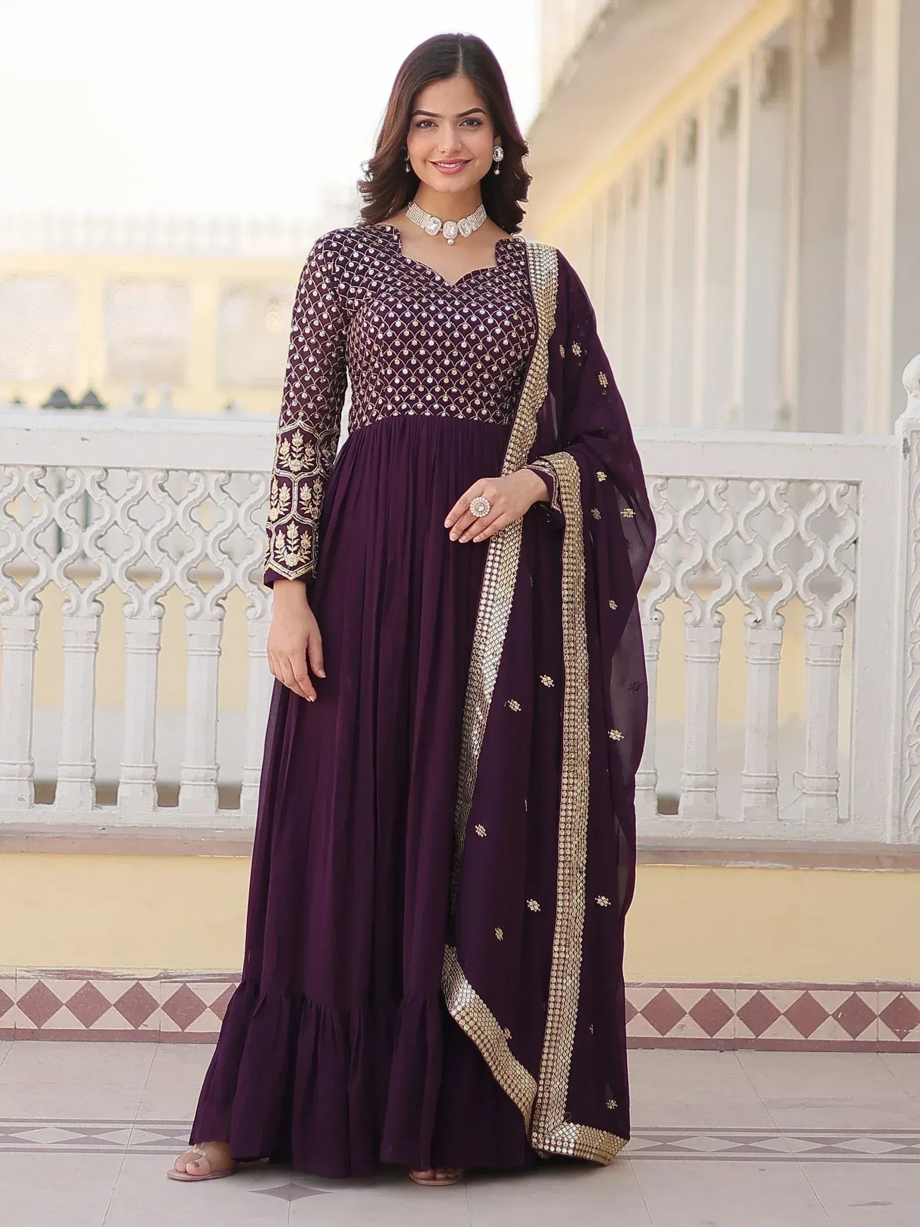 Elegant purple ethnic gown with gold embroidery and dupatta, perfect for Indian celebrations