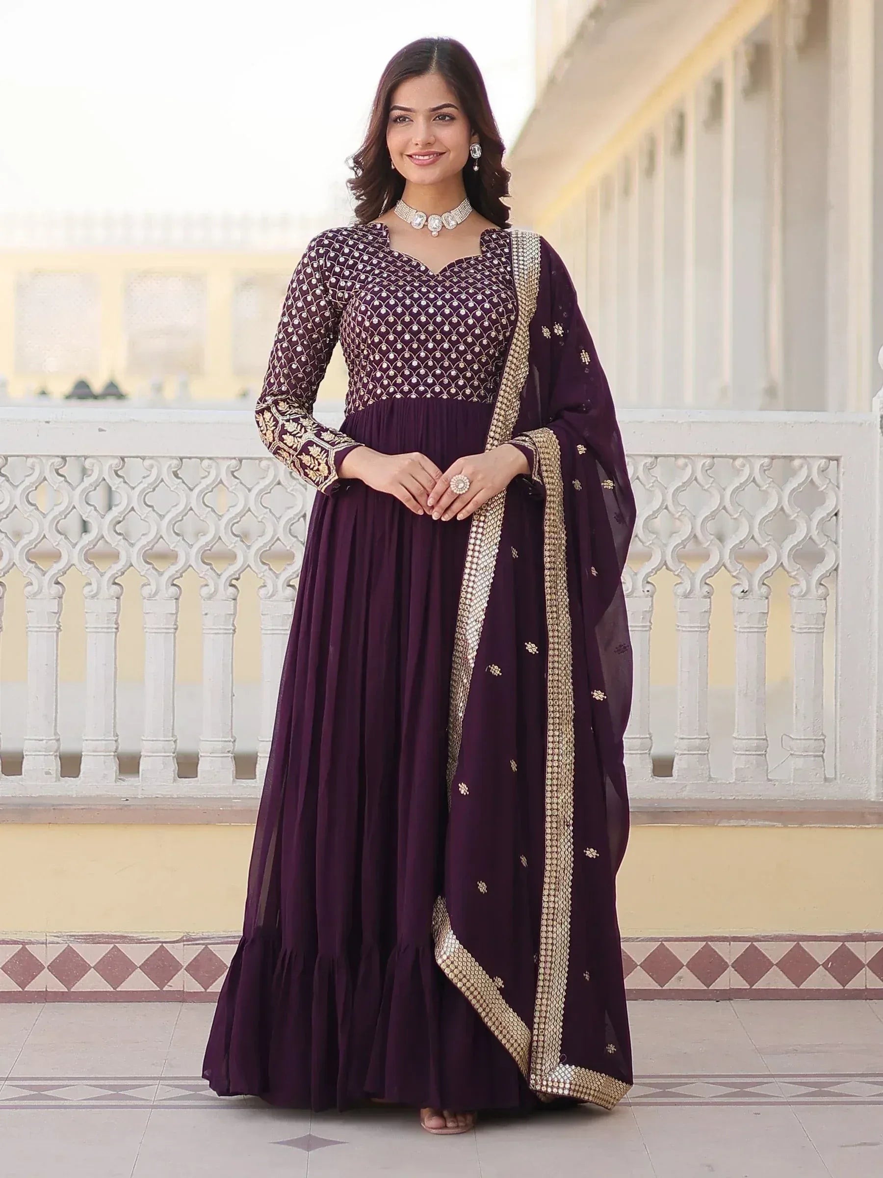 Elegant purple ethnic gown with gold embroidery and dupatta, perfect for Indian occasions