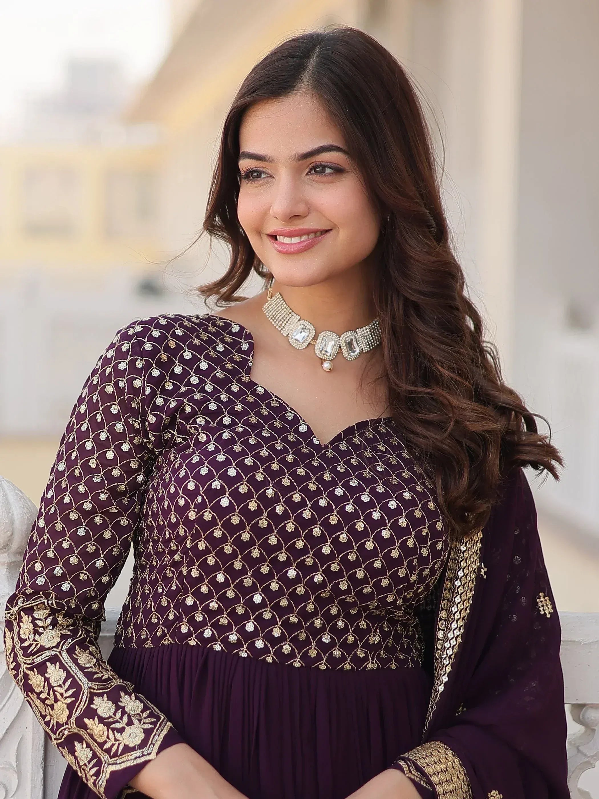 Elegant purple ethnic gown with gold embroidery, perfect for Indian occasions and festive wear.