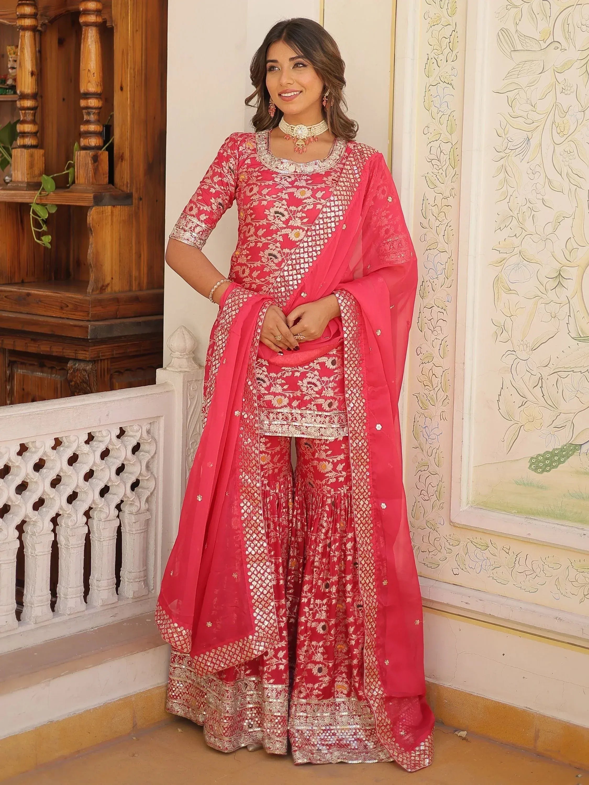 Pink embroidered Indian salwar kameez with floral motifs and sequin detailing, perfect for festive occasions.