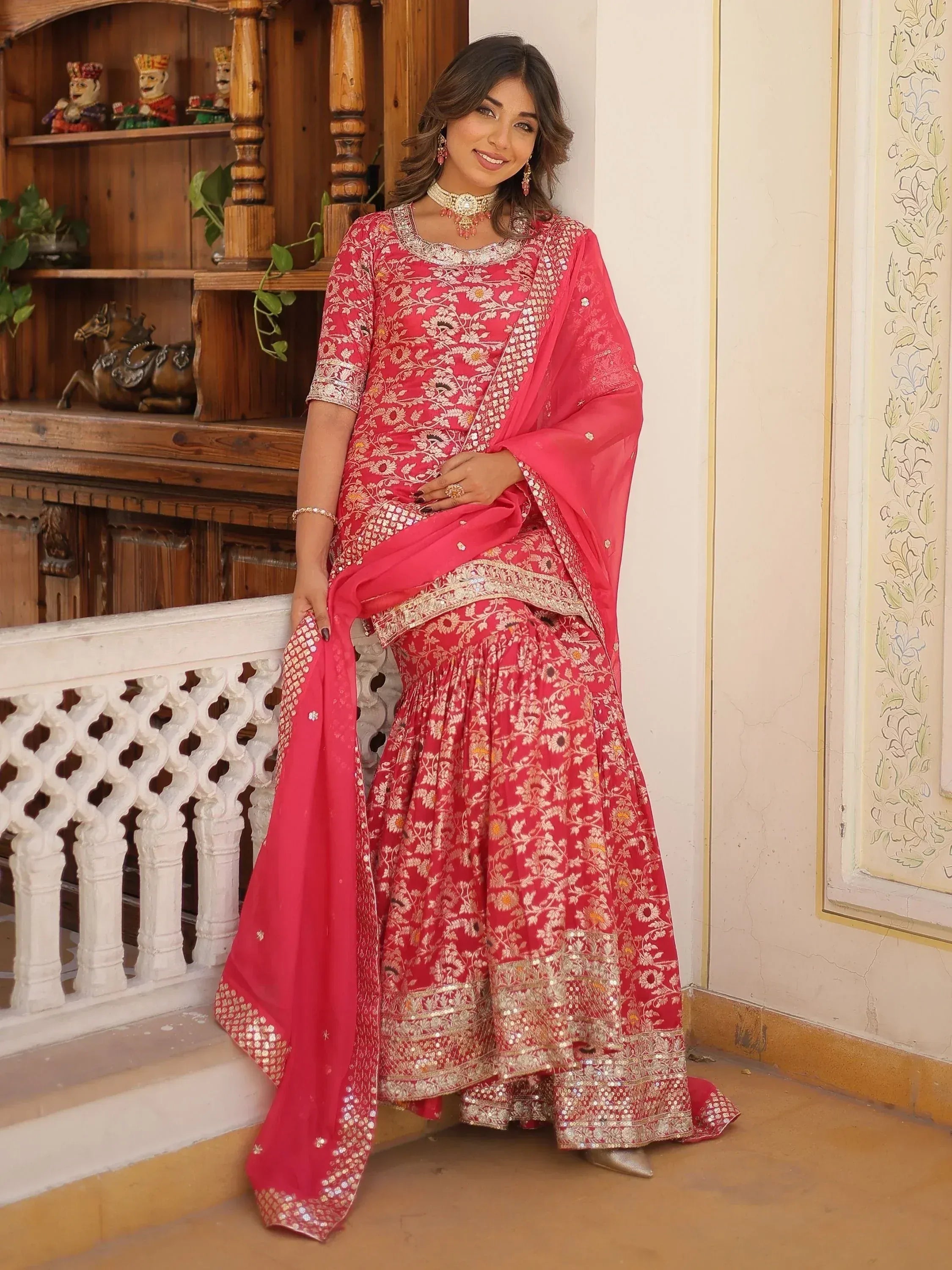 Woman in pink floral embroidered lehenga choli with dupatta, traditional Indian ethnic wear