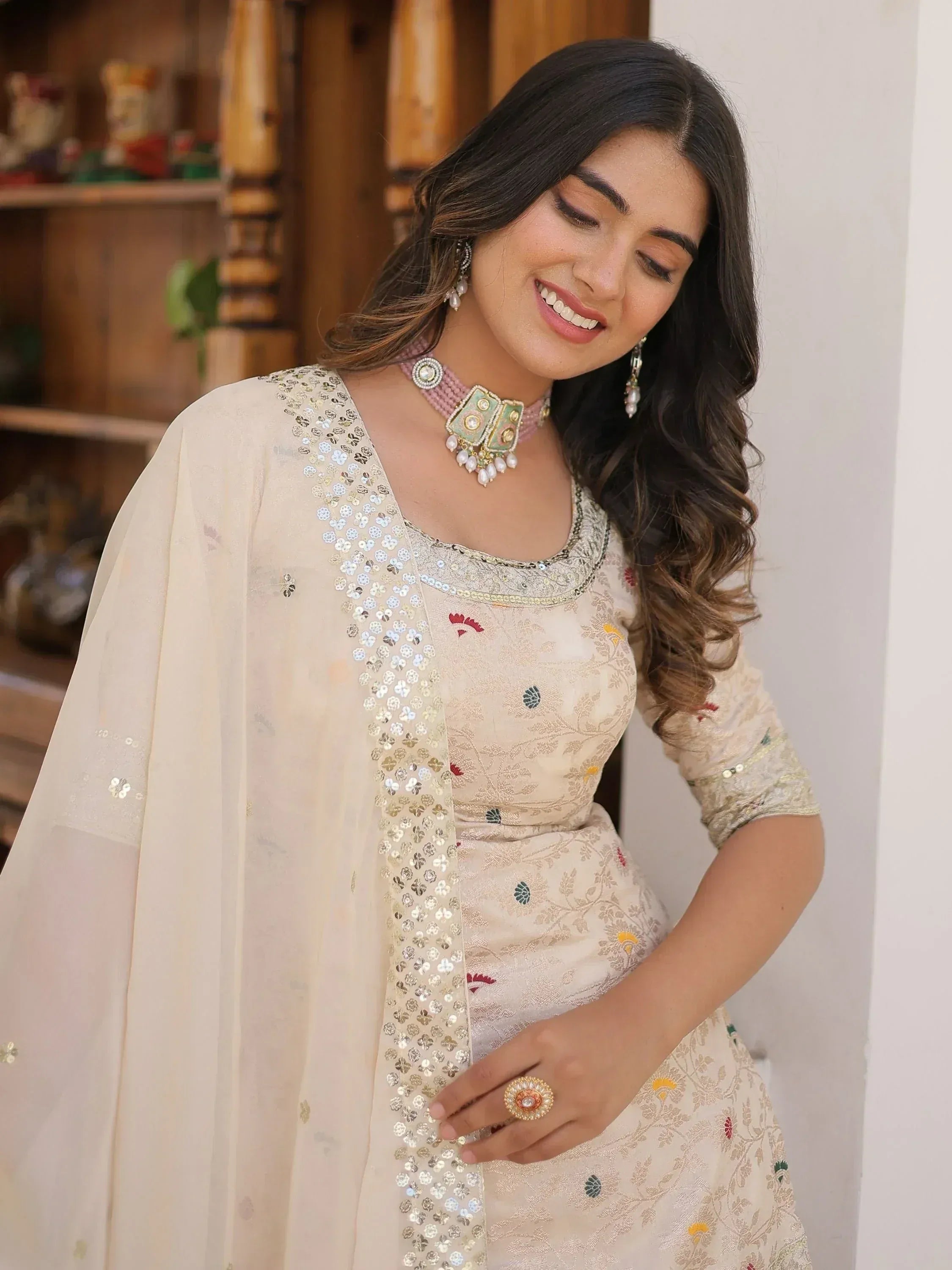 Elegant cream ethnic gown with floral embroidery and sequin dupatta, perfect for Indian occasions.