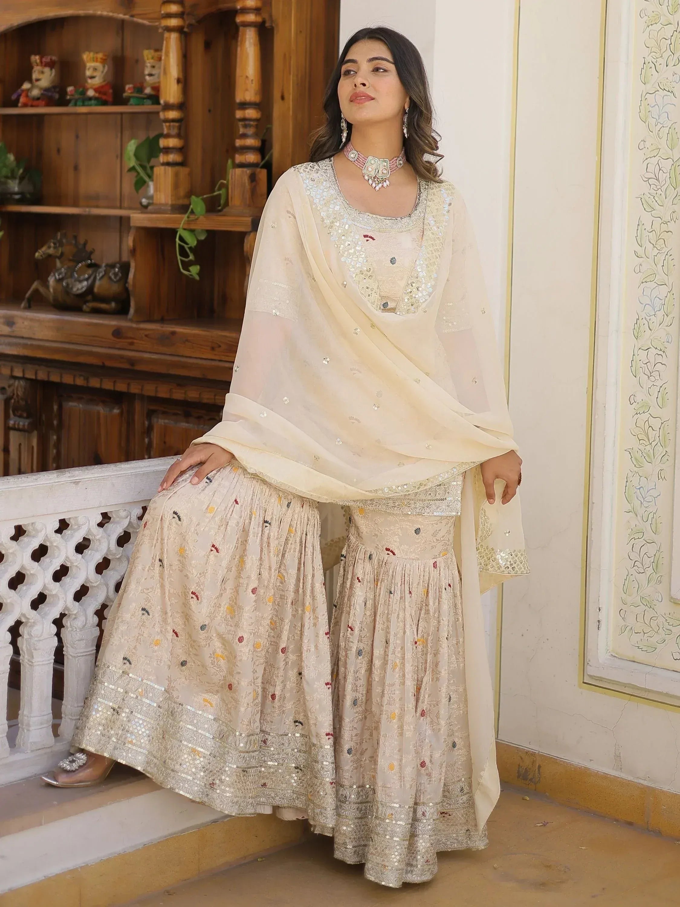 Elegant cream ethnic sharara set with sequin embroidery, perfect for Indian weddings and festive occasions.