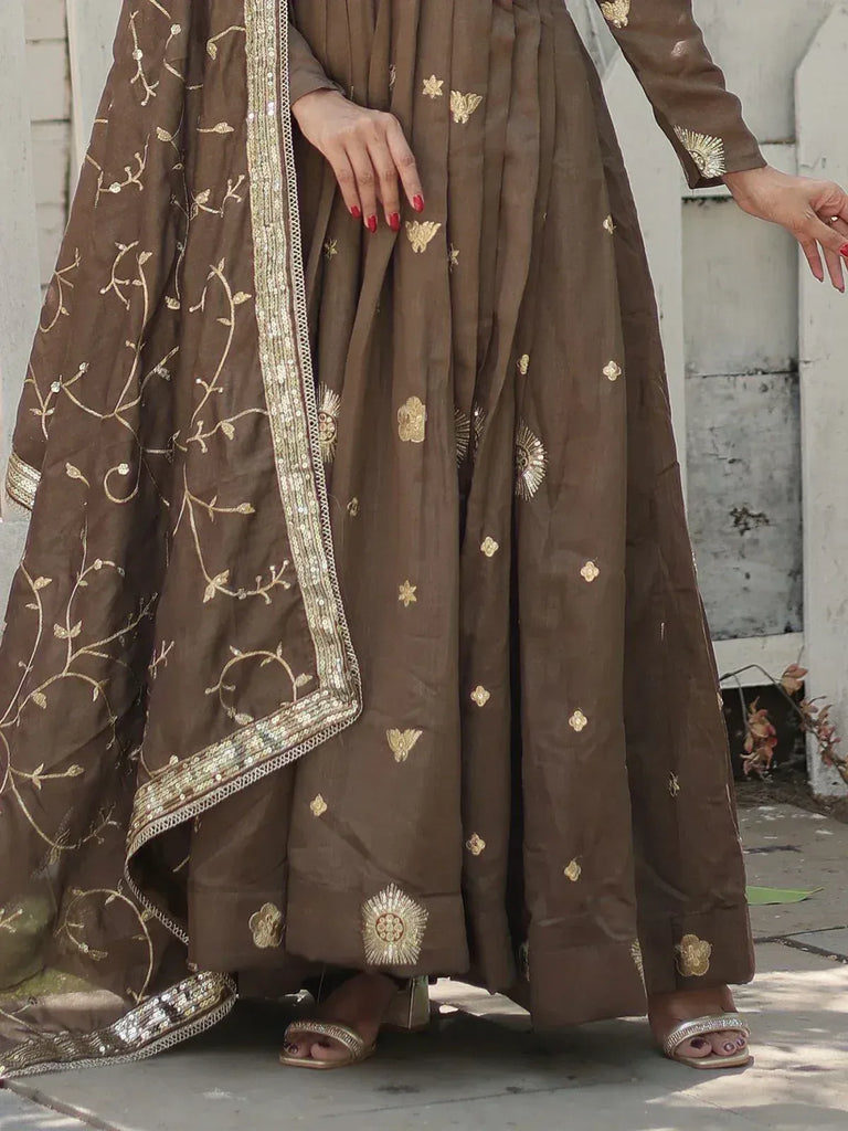 Brown ethnic anarkali with gold embroidery and sequin dupatta, perfect for Indian weddings or festive occasions.