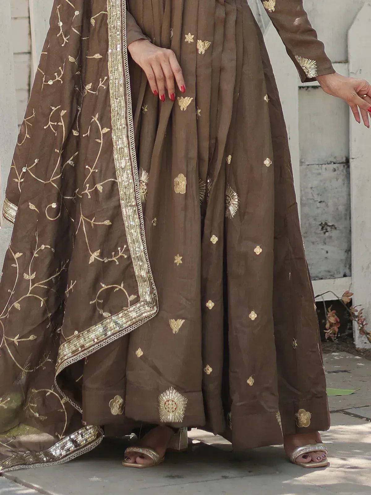 Brown ethnic anarkali with gold embroidery and sequin dupatta, perfect for Indian weddings or festive occasions.