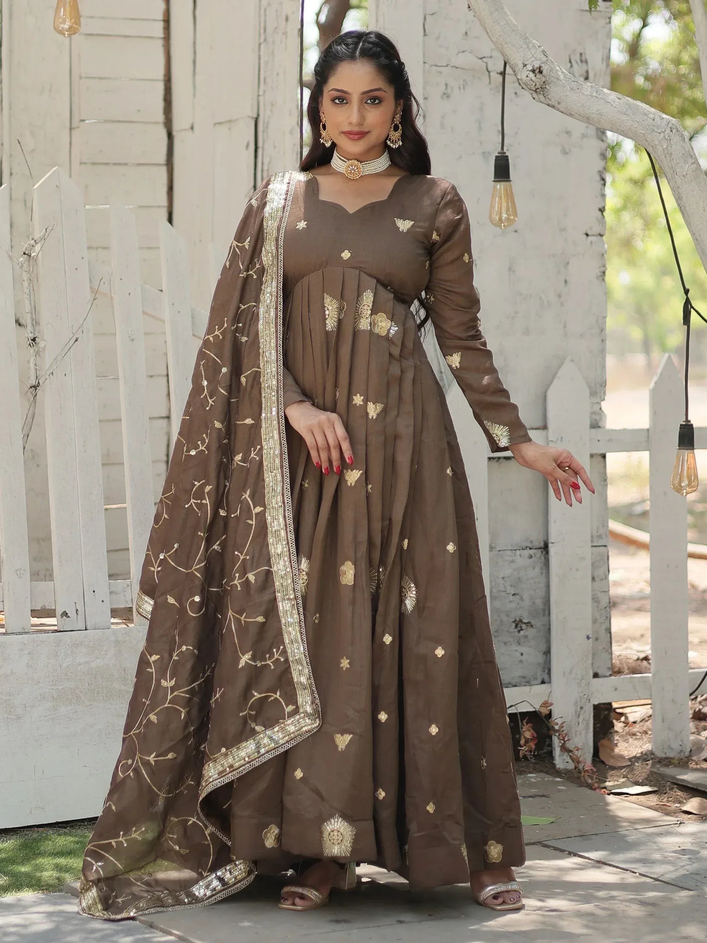 Brown ethnic anarkali suit with gold embroidery and dupatta, perfect for Indian occasions