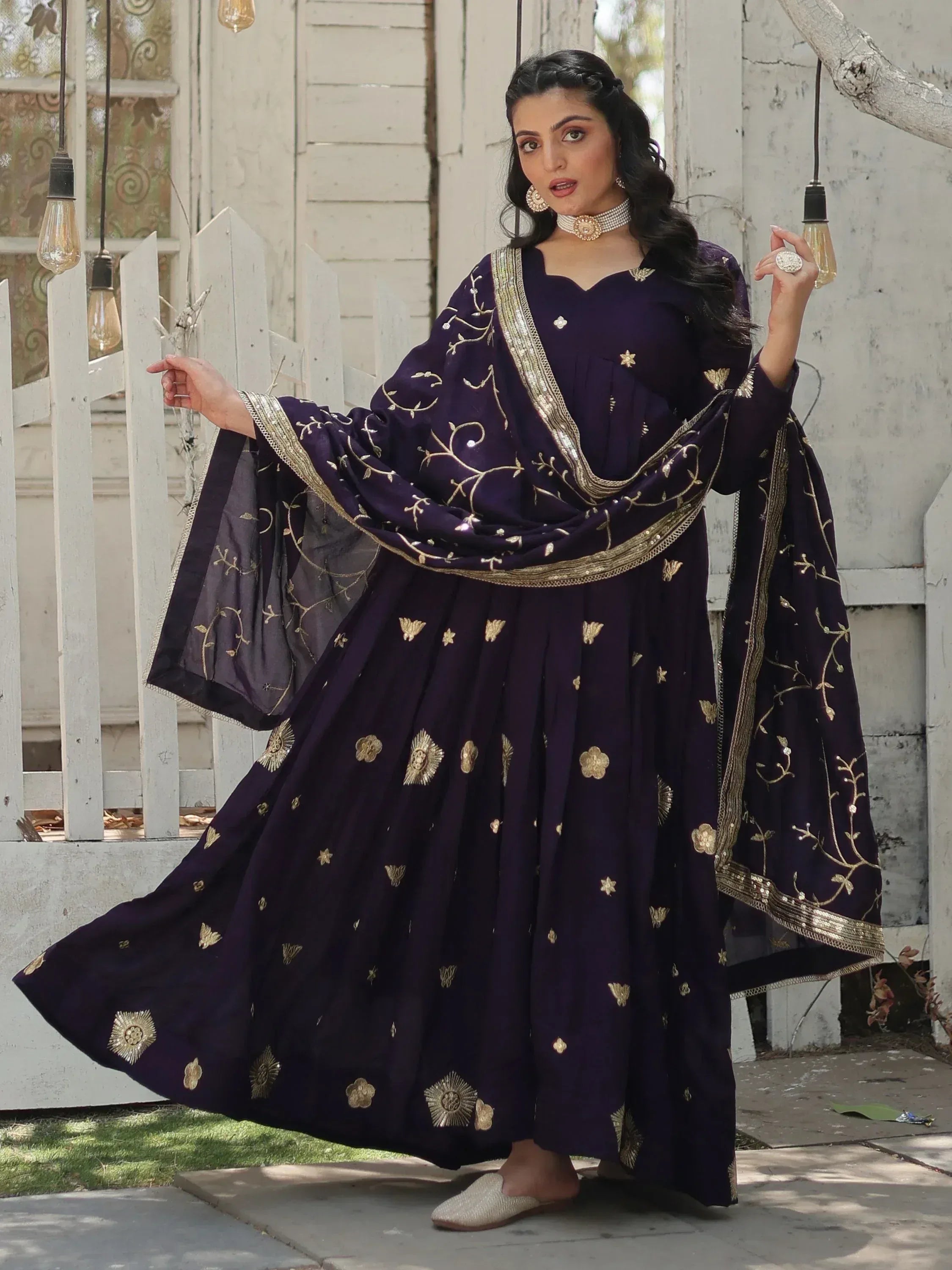 Elegant purple ethnic gown with gold embroidery, perfect for Indian occasions and festive wear.