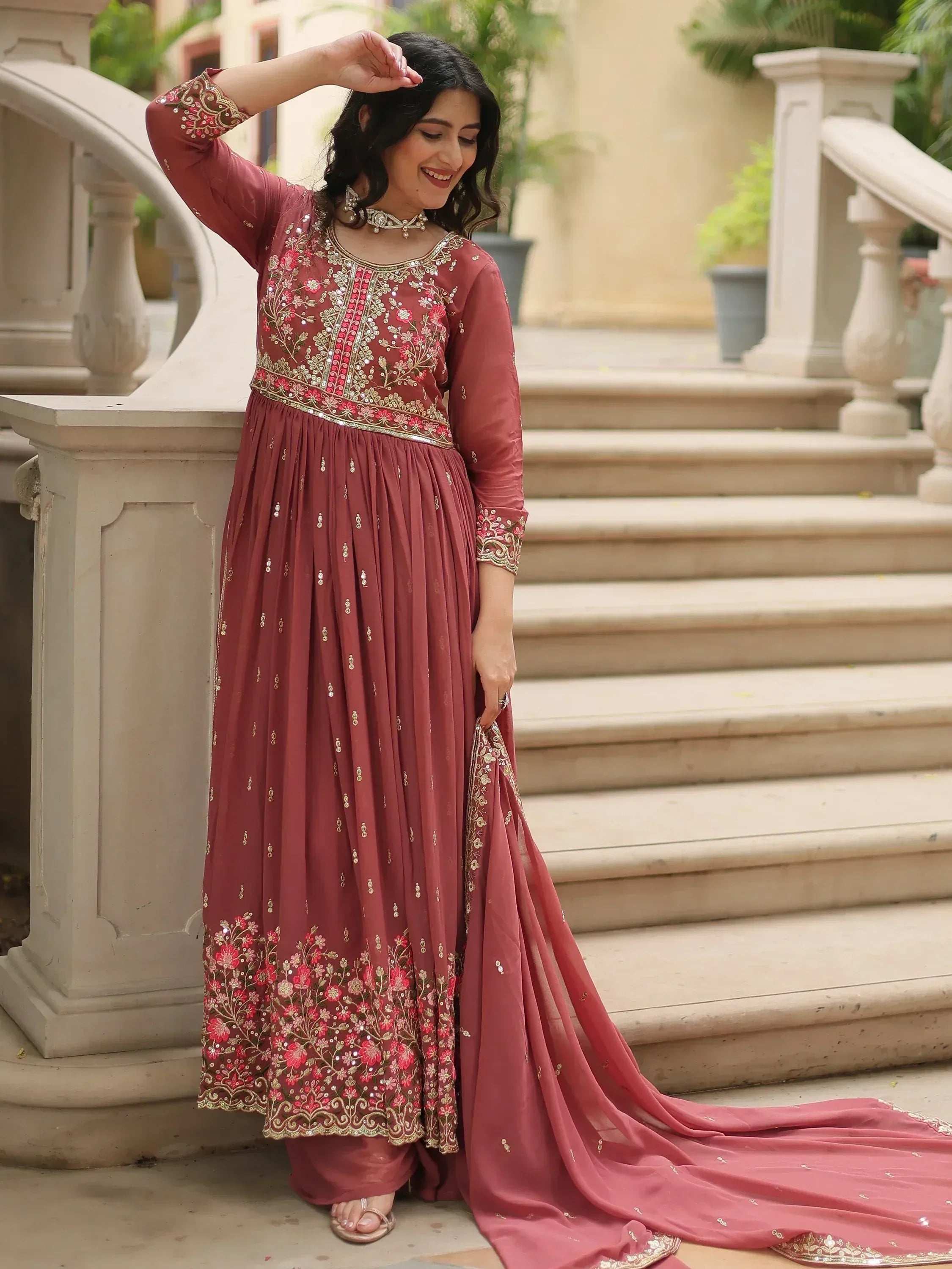 Elegant maroon ethnic gown with floral embroidery, perfect for Indian occasions and celebrations.