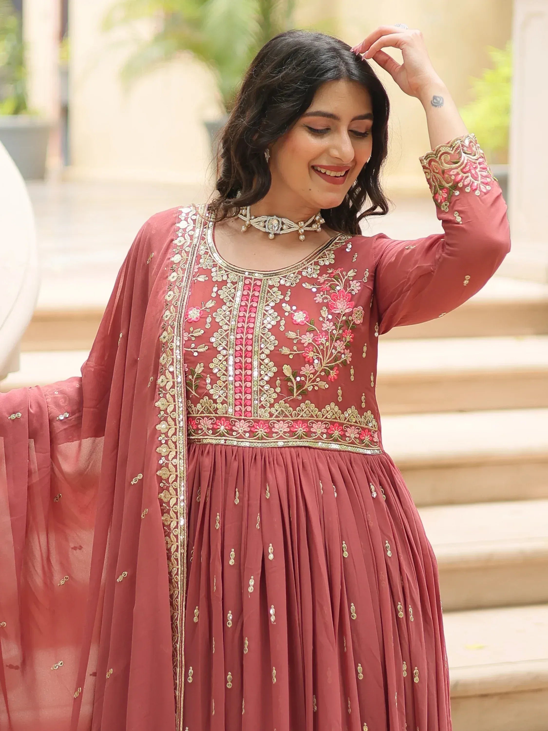 Dusty rose ethnic gown with floral embroidery and gold detailing, perfect for Indian celebrations