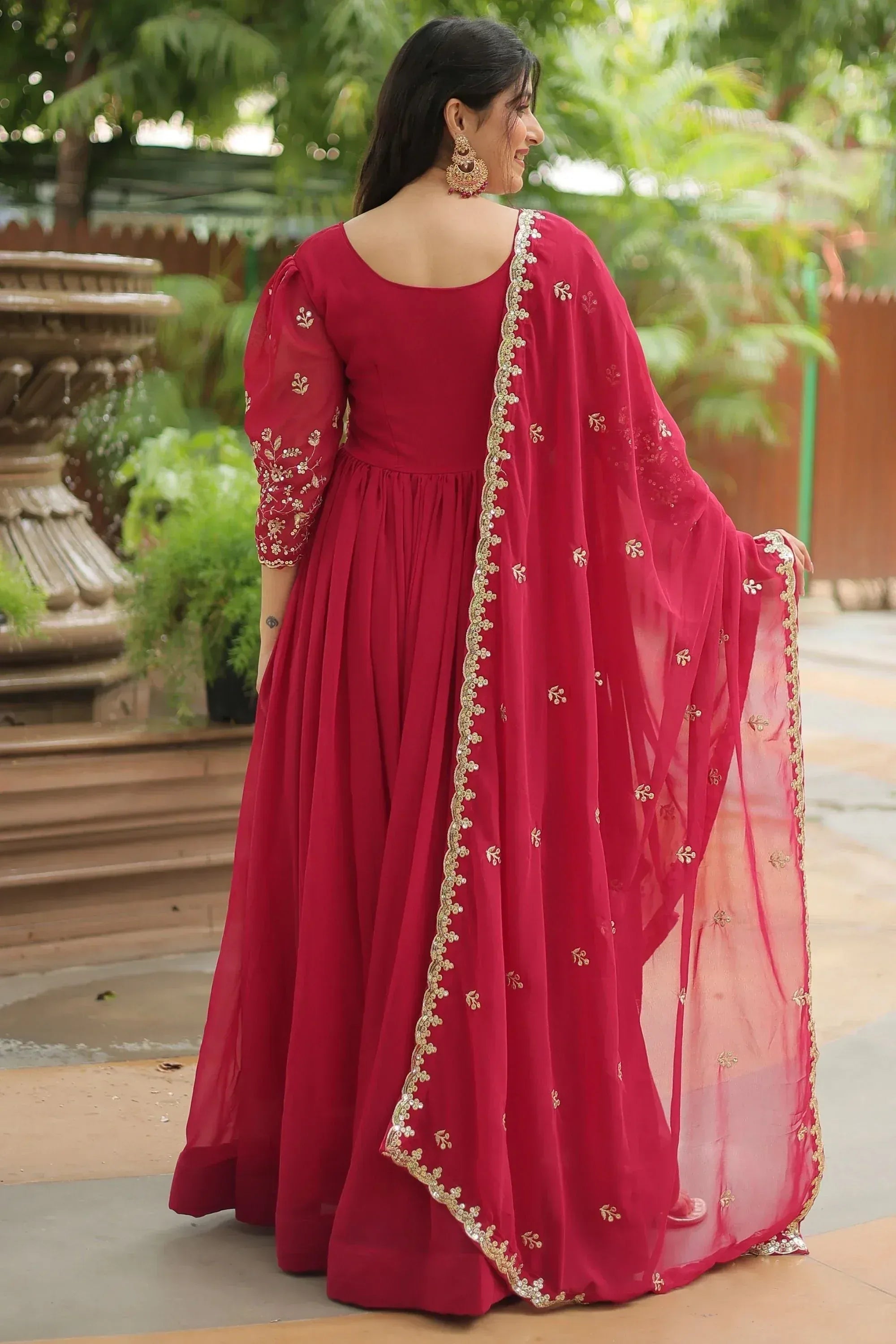 Elegant maroon ethnic gown with gold embroidery and sheer dupatta for festive occasions