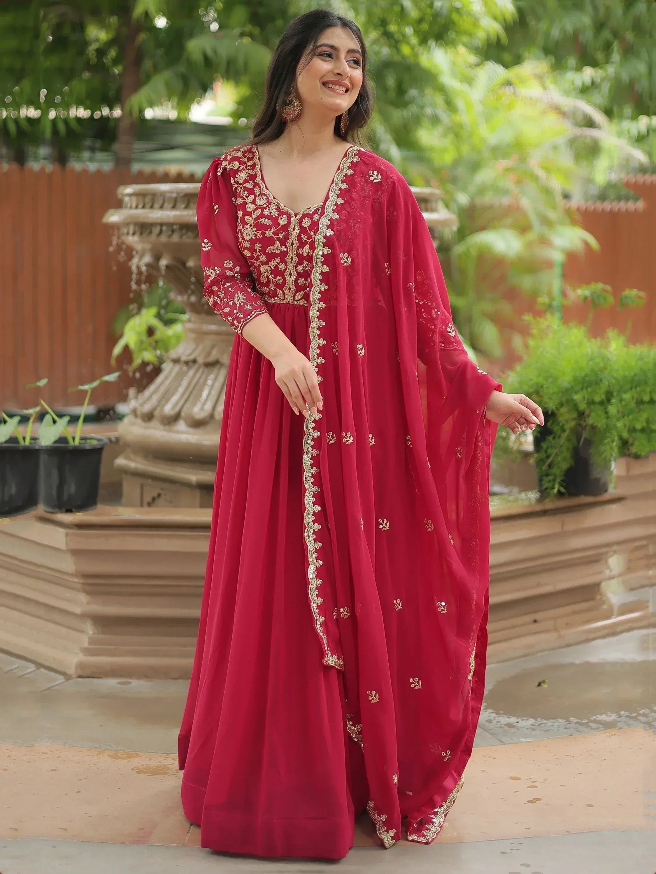 Red embroidered ethnic gown with gold detailing, perfect for Indian occasions and festive wear.