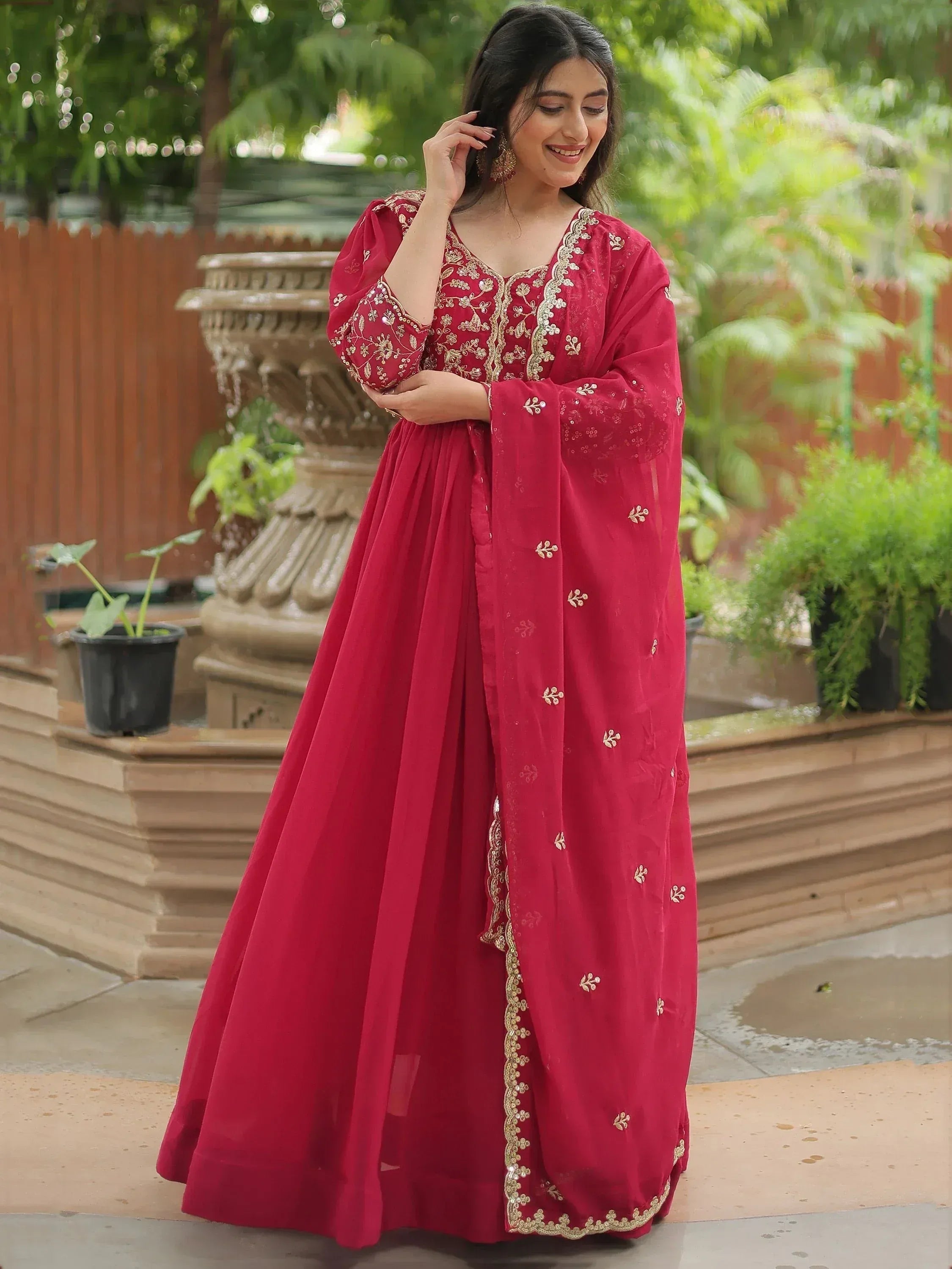 Red embroidered ethnic gown with gold detailing, perfect for festive occasions