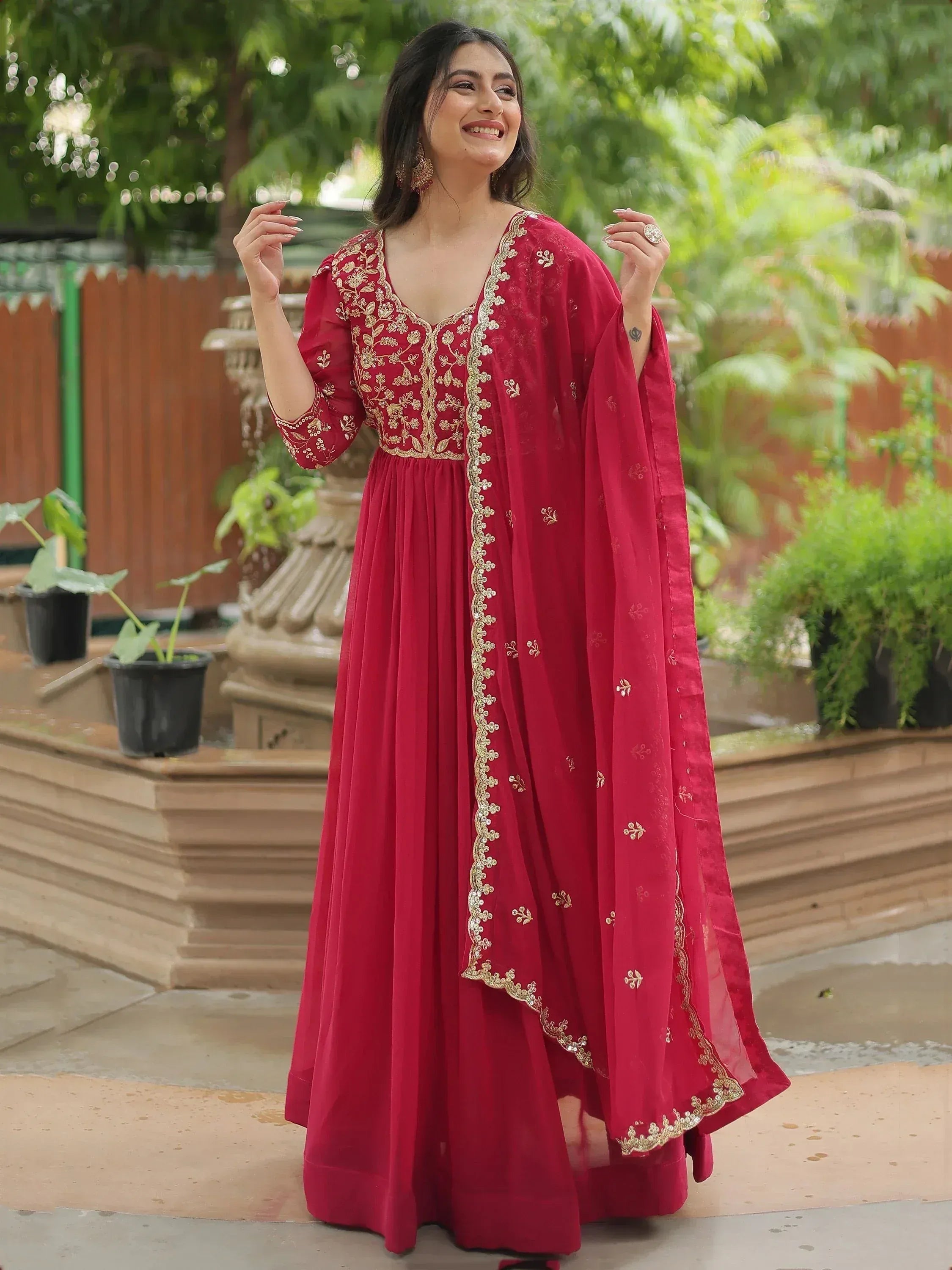 Red ethnic anarkali gown with gold embroidery, perfect for Indian occasions and festive wear.