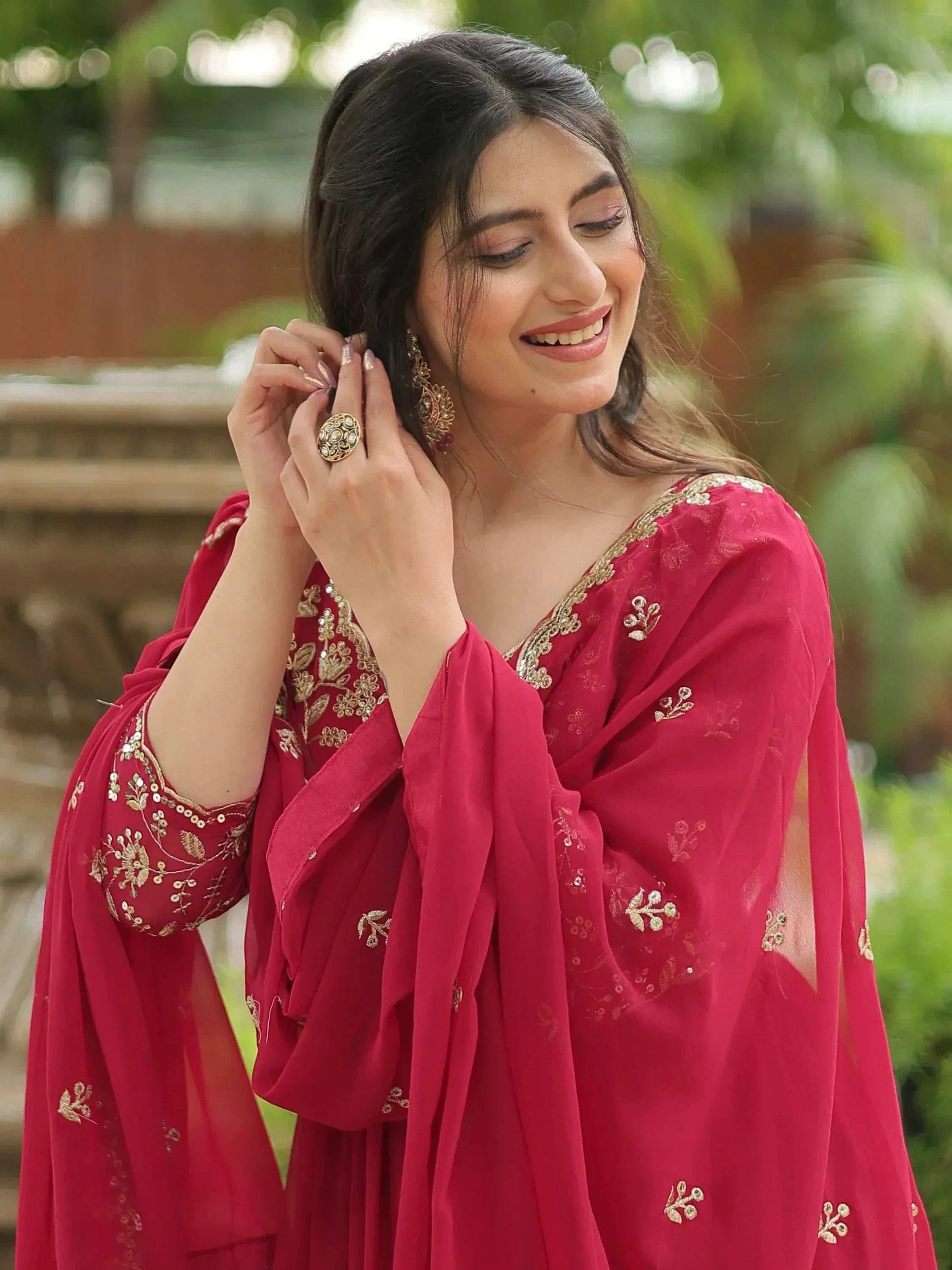 Red embroidered ethnic gown with gold detailing, perfect for festive occasions
