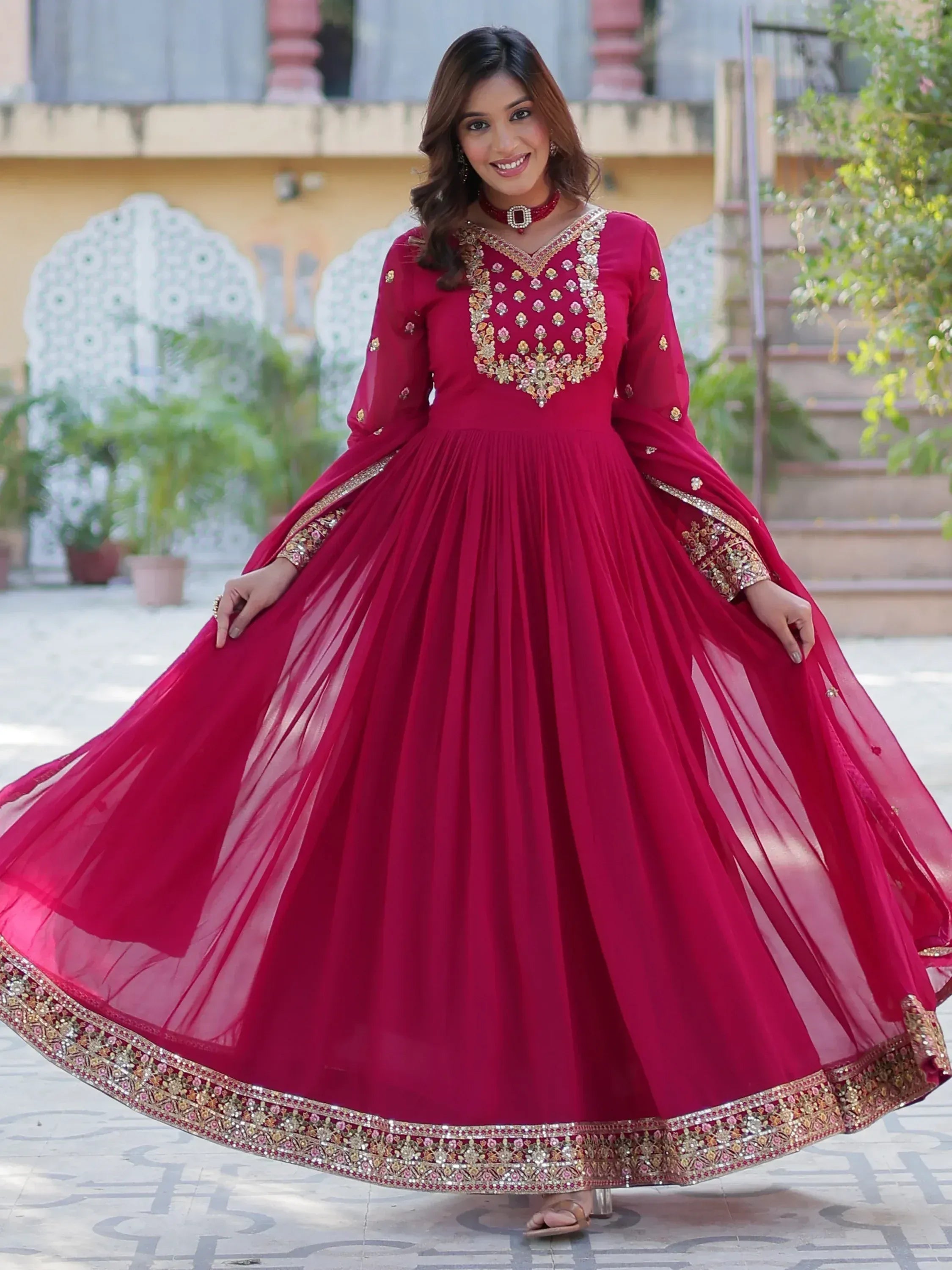 Woman in maroon embroidered anarkali gown with gold detailing, perfect for Indian ethnic occasions