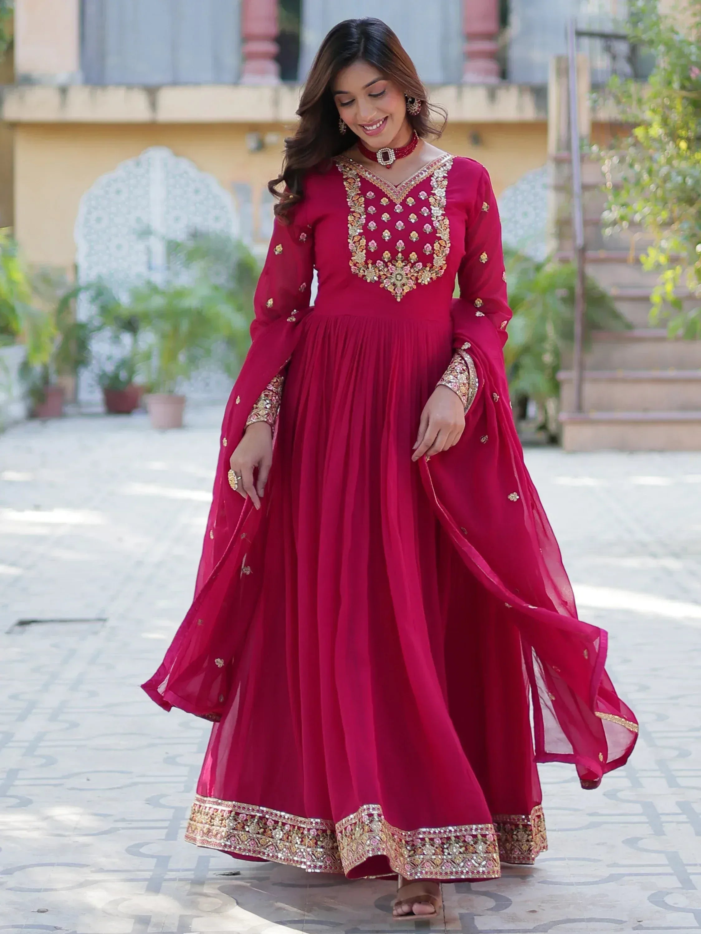 Elegant maroon ethnic gown with gold embroidery, perfect for Indian weddings and festive occasions