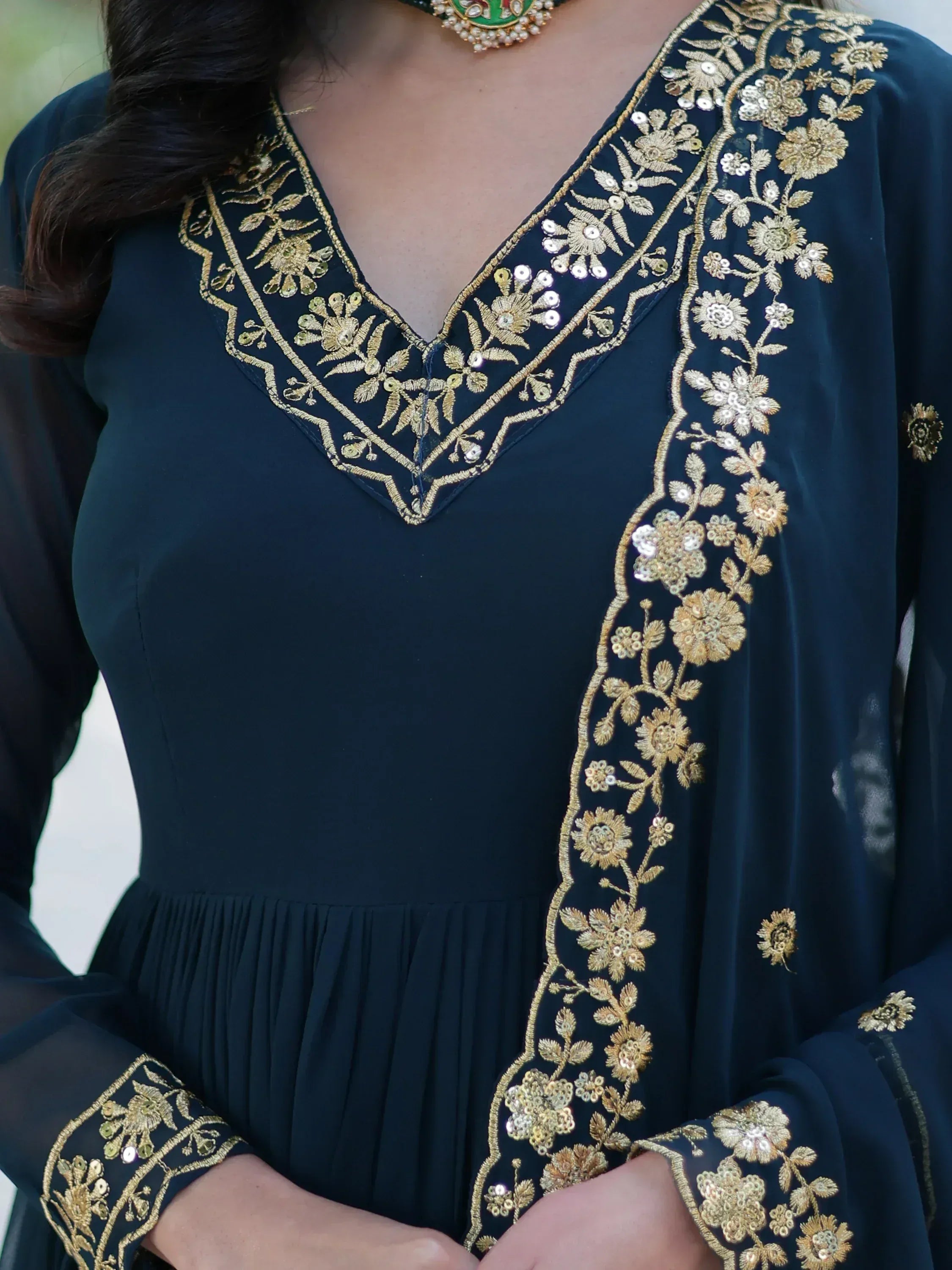 Dark blue ethnic gown with gold floral embroidery and sequins, perfect for Indian occasions.