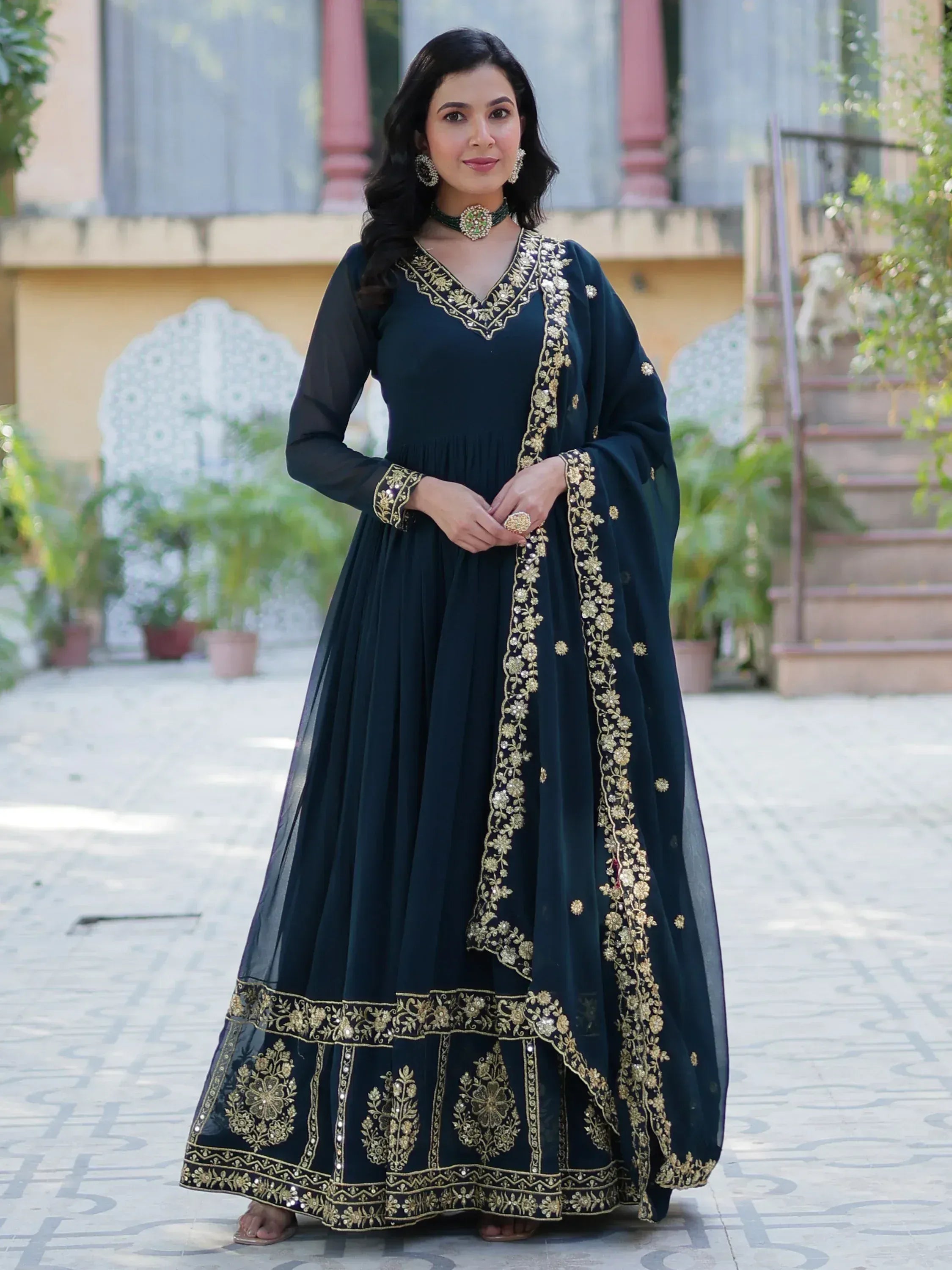 Dark green ethnic gown with gold embroidery, perfect for Indian occasions and festive wear