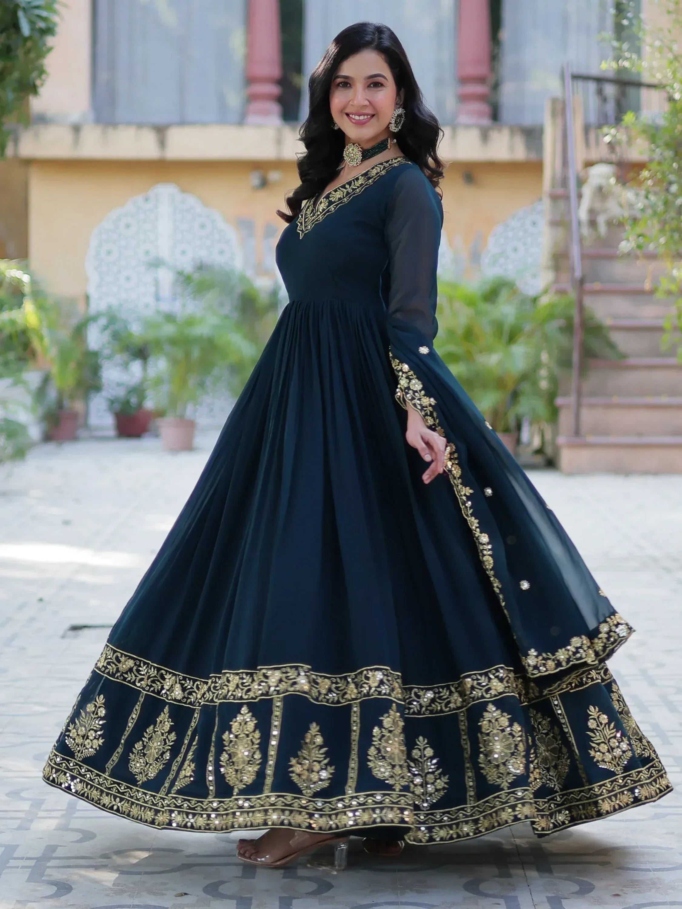 Woman in navy blue ethnic gown with gold embroidery, perfect for Indian festive occasions and weddings