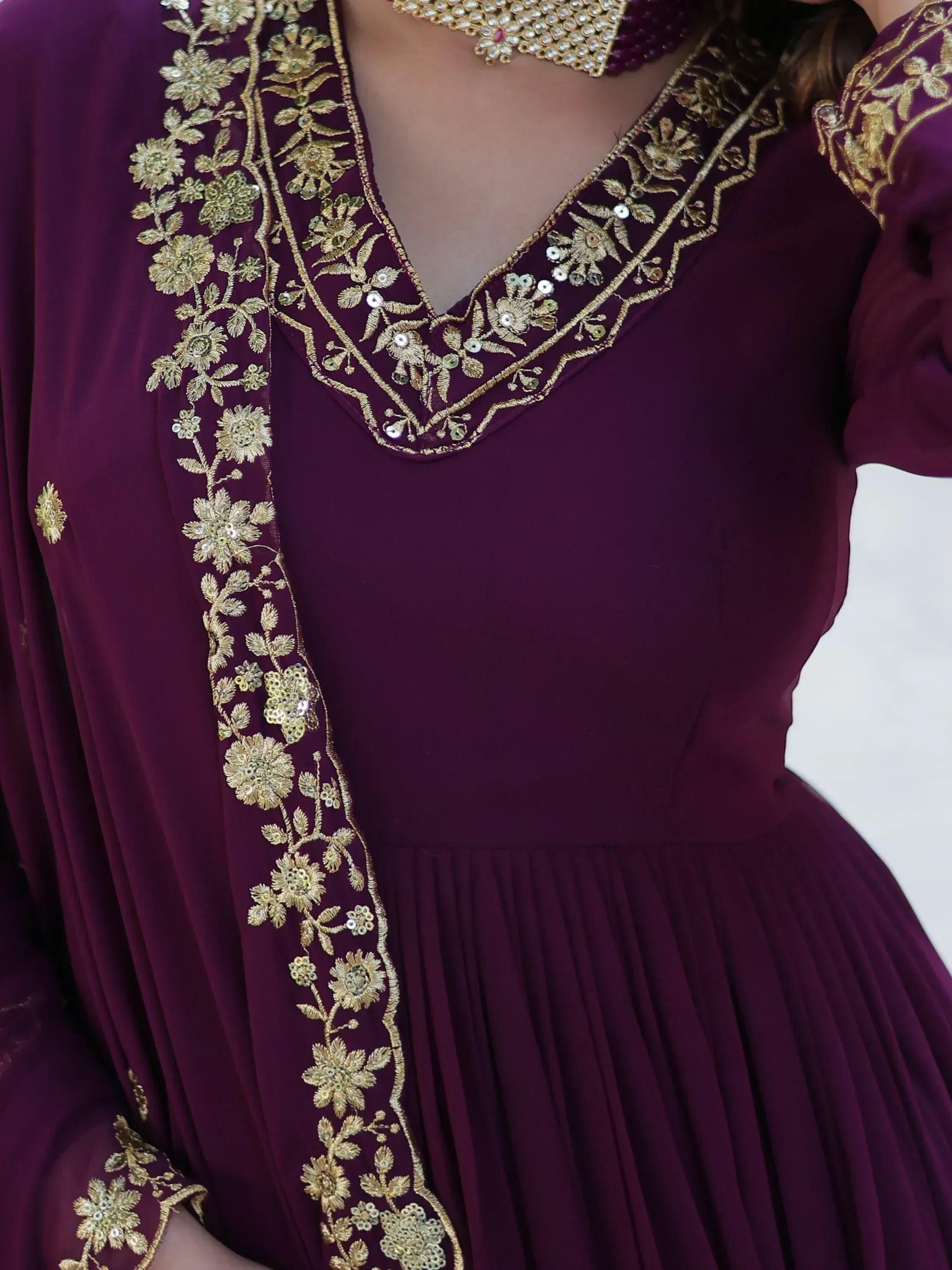 Purple ethnic gown with gold floral embroidery and sequins, V-neck design, pleated skirt