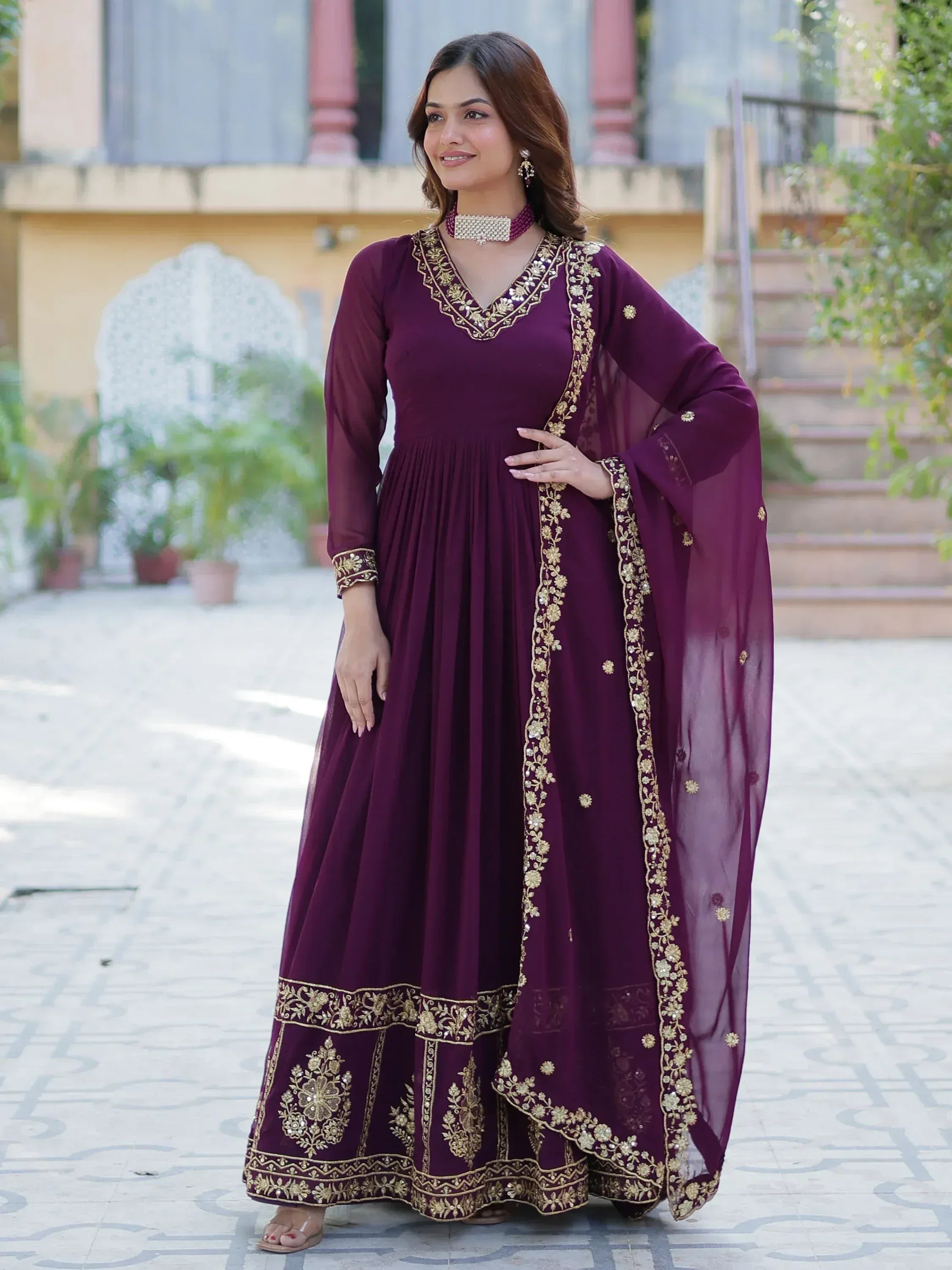 Elegant maroon ethnic gown with gold embroidery, perfect for Indian celebrations and events.