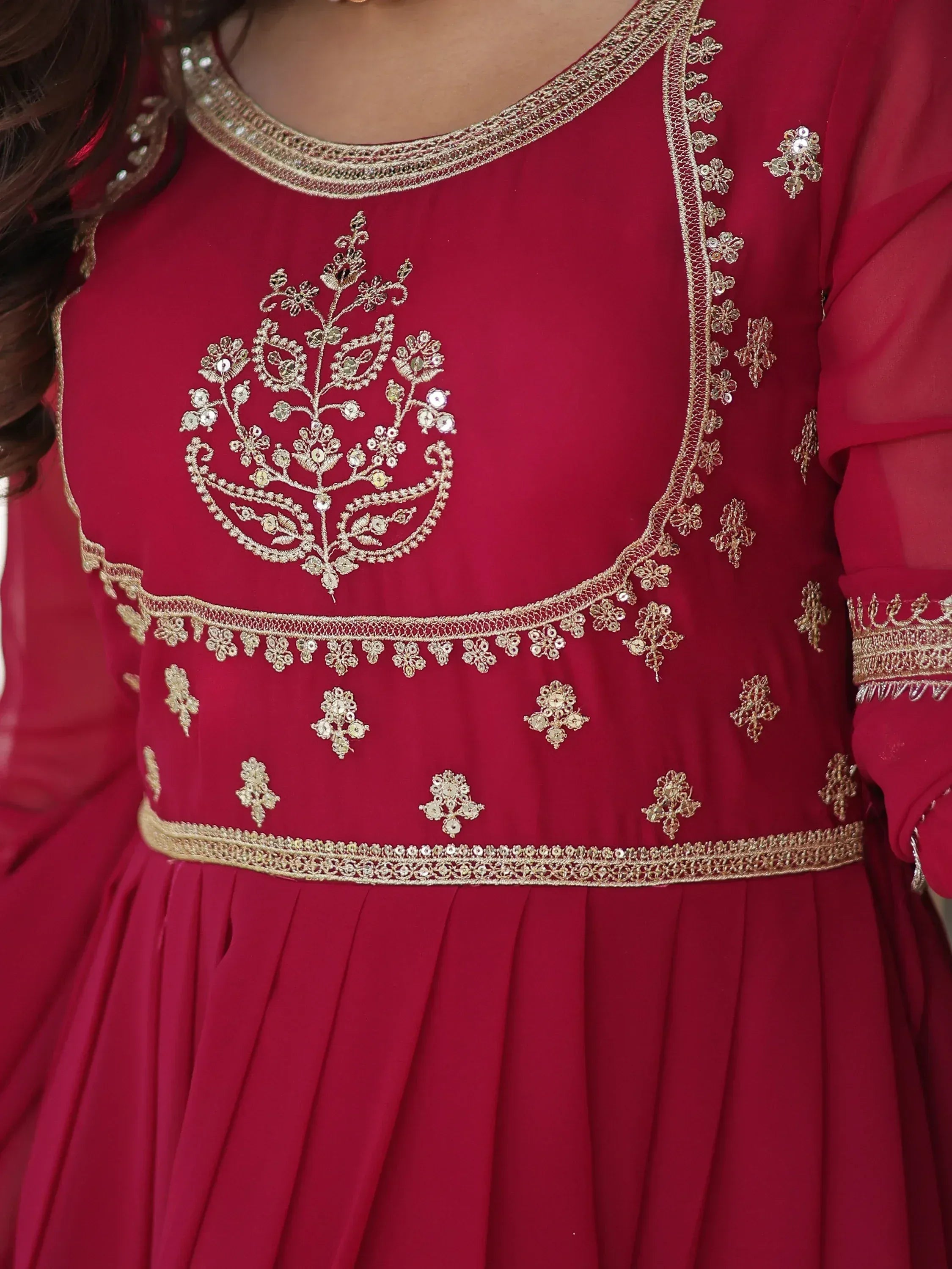 Red ethnic gown with gold floral embroidery and sequin detailing, perfect for Indian occasions