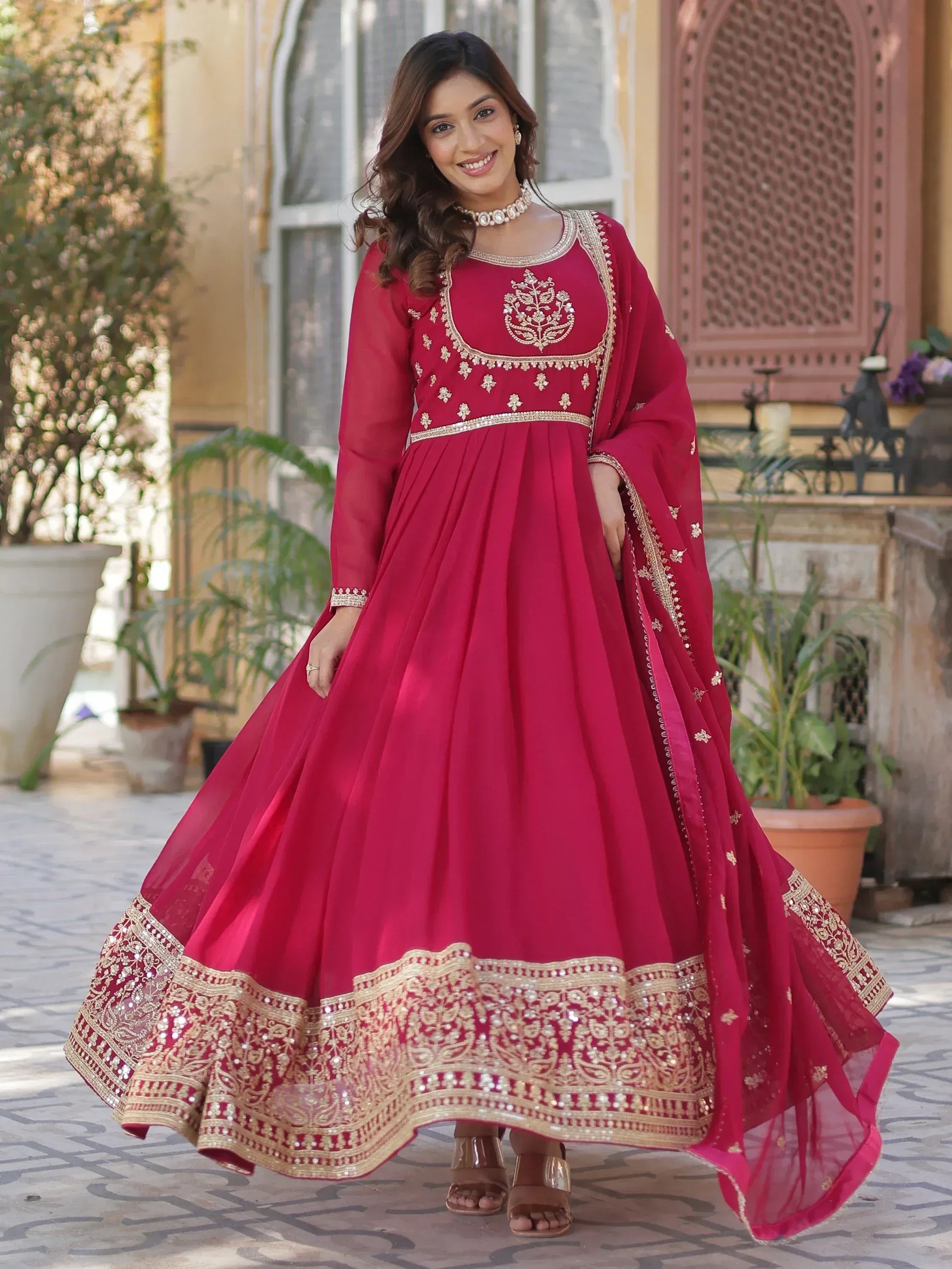 Red ethnic anarkali gown with gold embroidery, perfect for Indian weddings and festive occasions