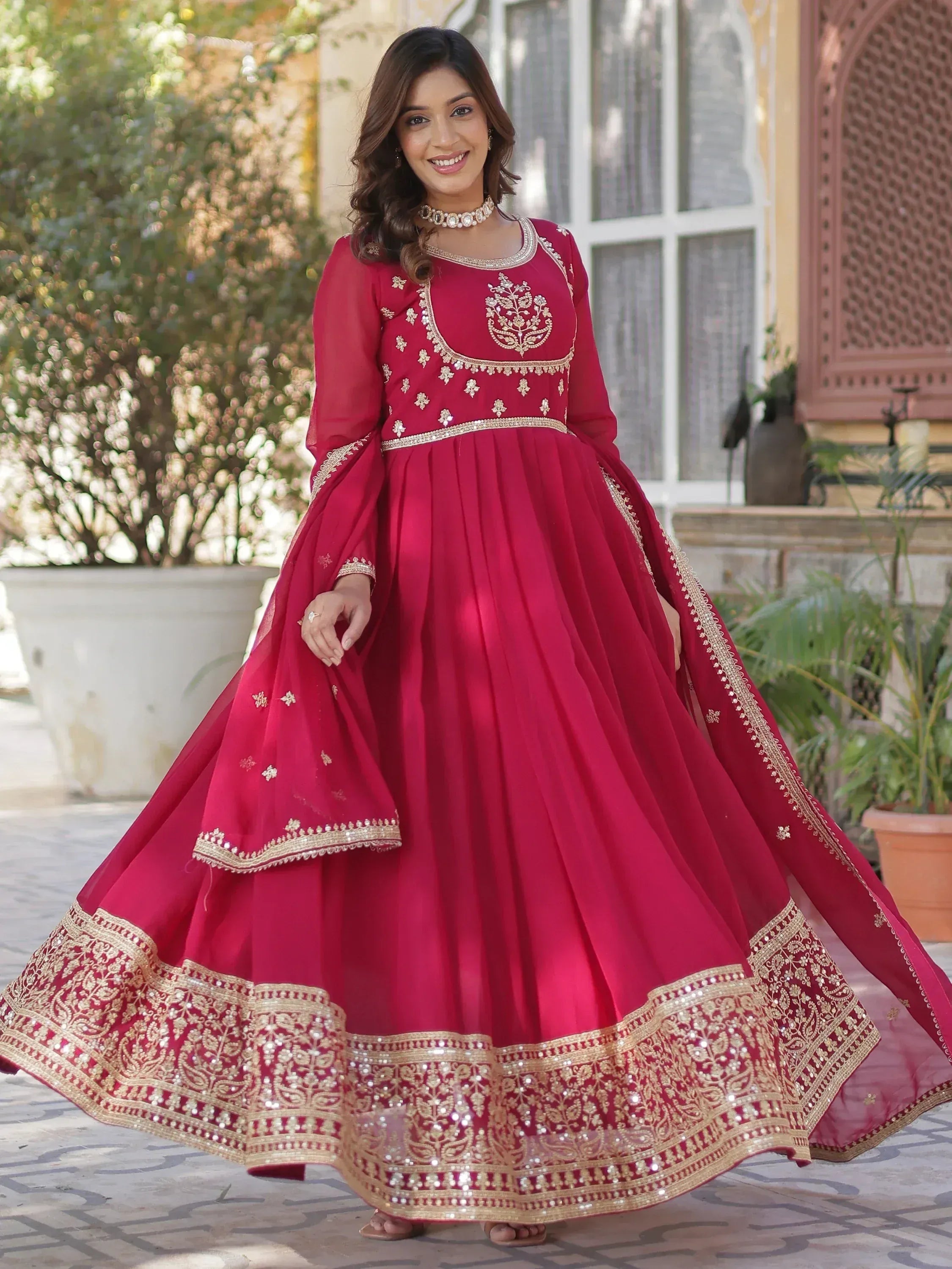 Red Indian Anarkali with gold embroidery, perfect for weddings and festive occasions