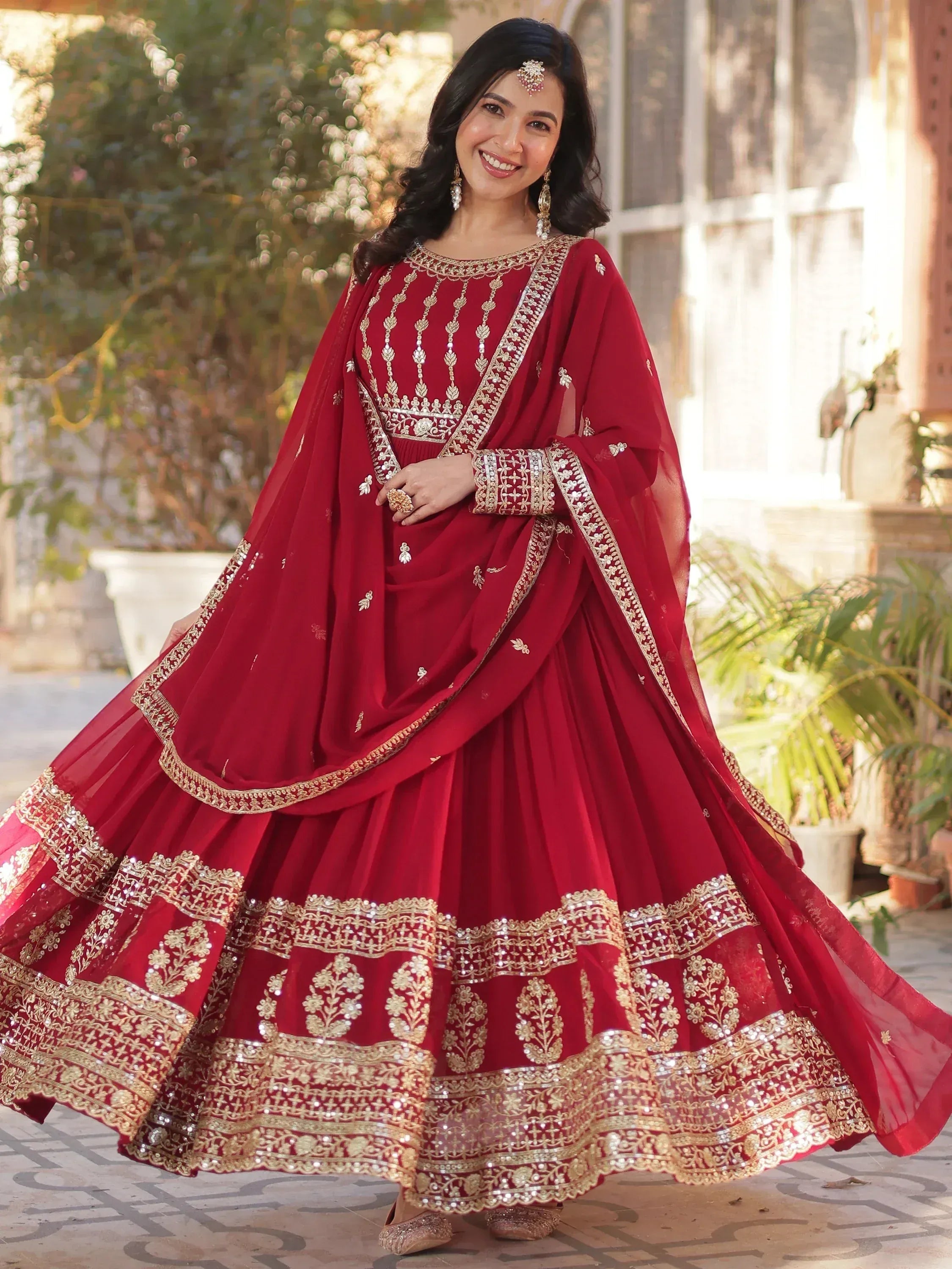 Red embroidered lehenga choli with gold detailing, perfect for Indian weddings and festive occasions.