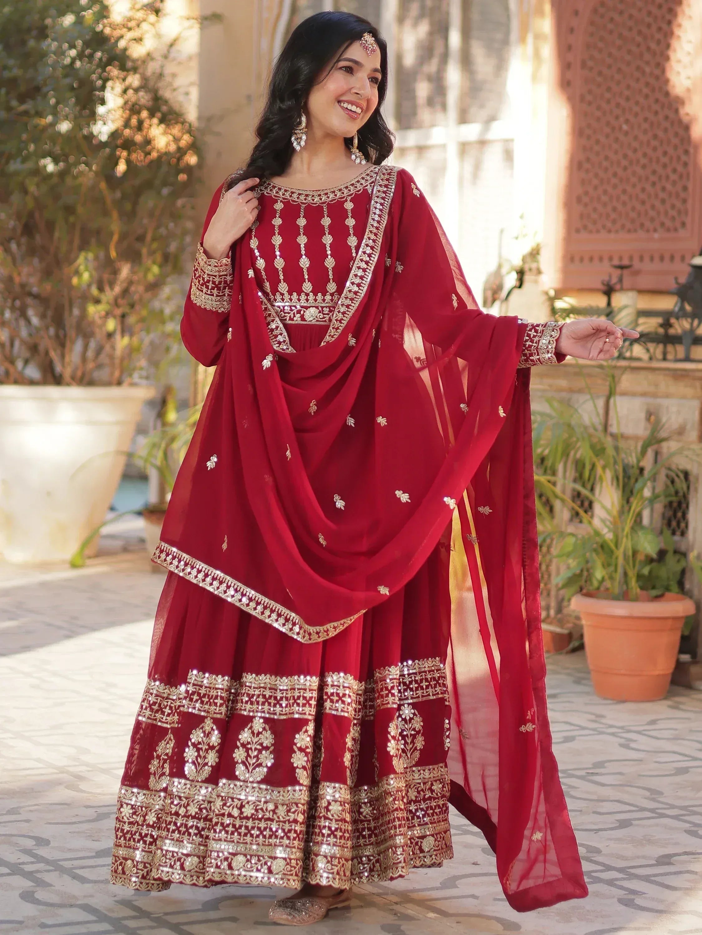 Red embroidered Indian salwar kameez with gold detailing, perfect for festive occasions and weddings.