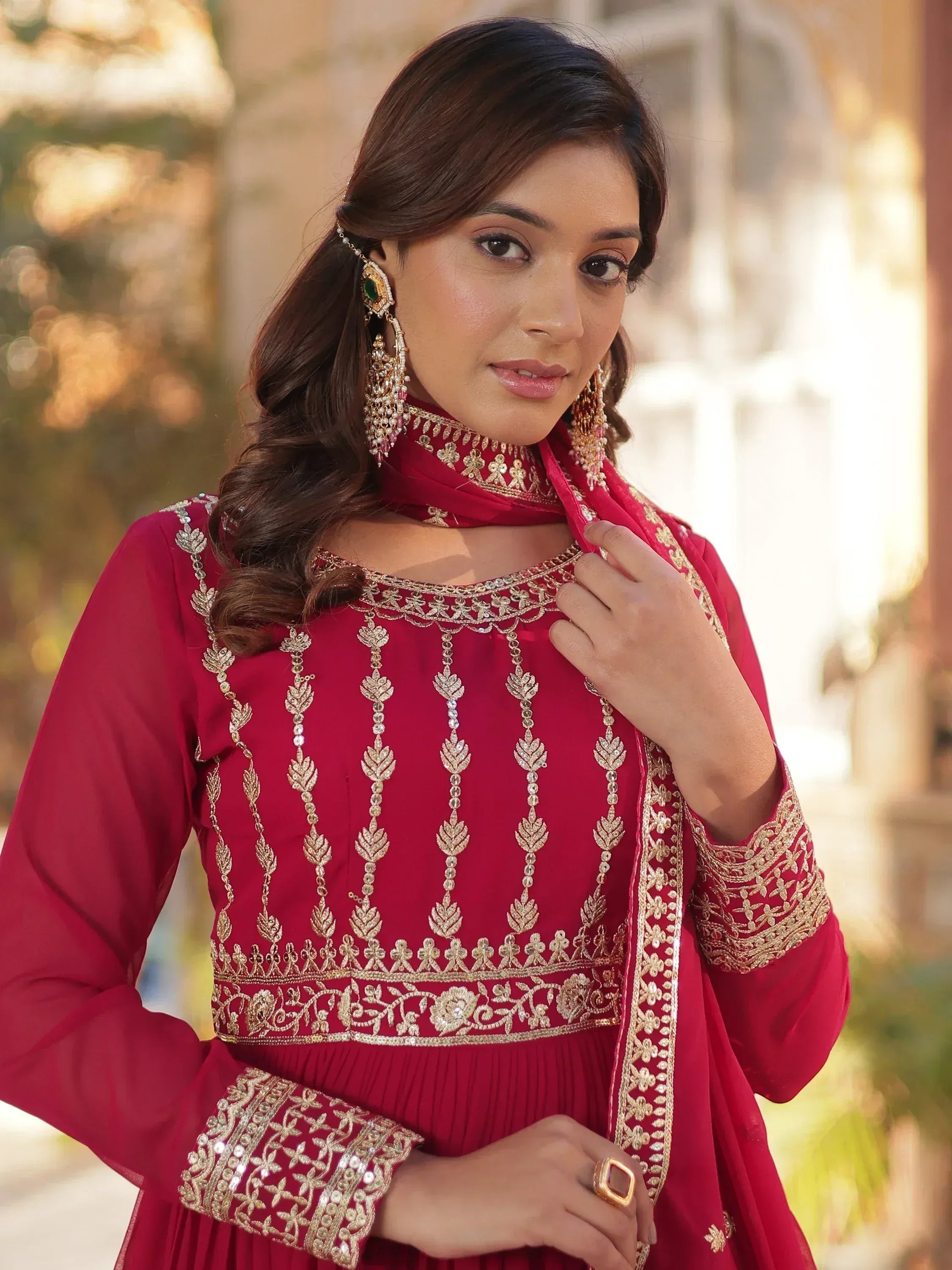 Red ethnic gown with gold embroidery, perfect for Indian weddings or festive occasions.