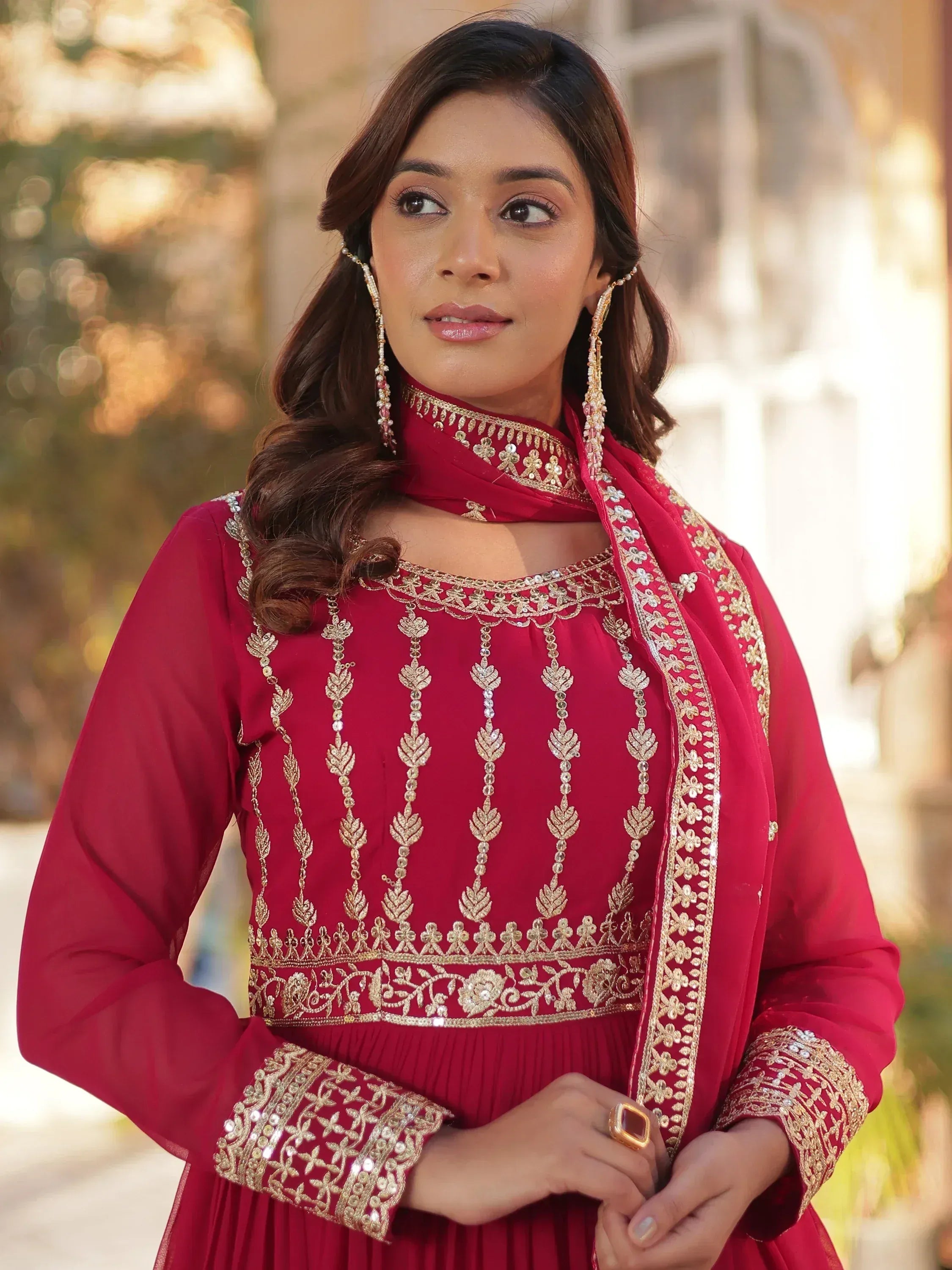 Red ethnic gown with gold embroidery and matching dupatta, perfect for Indian occasions