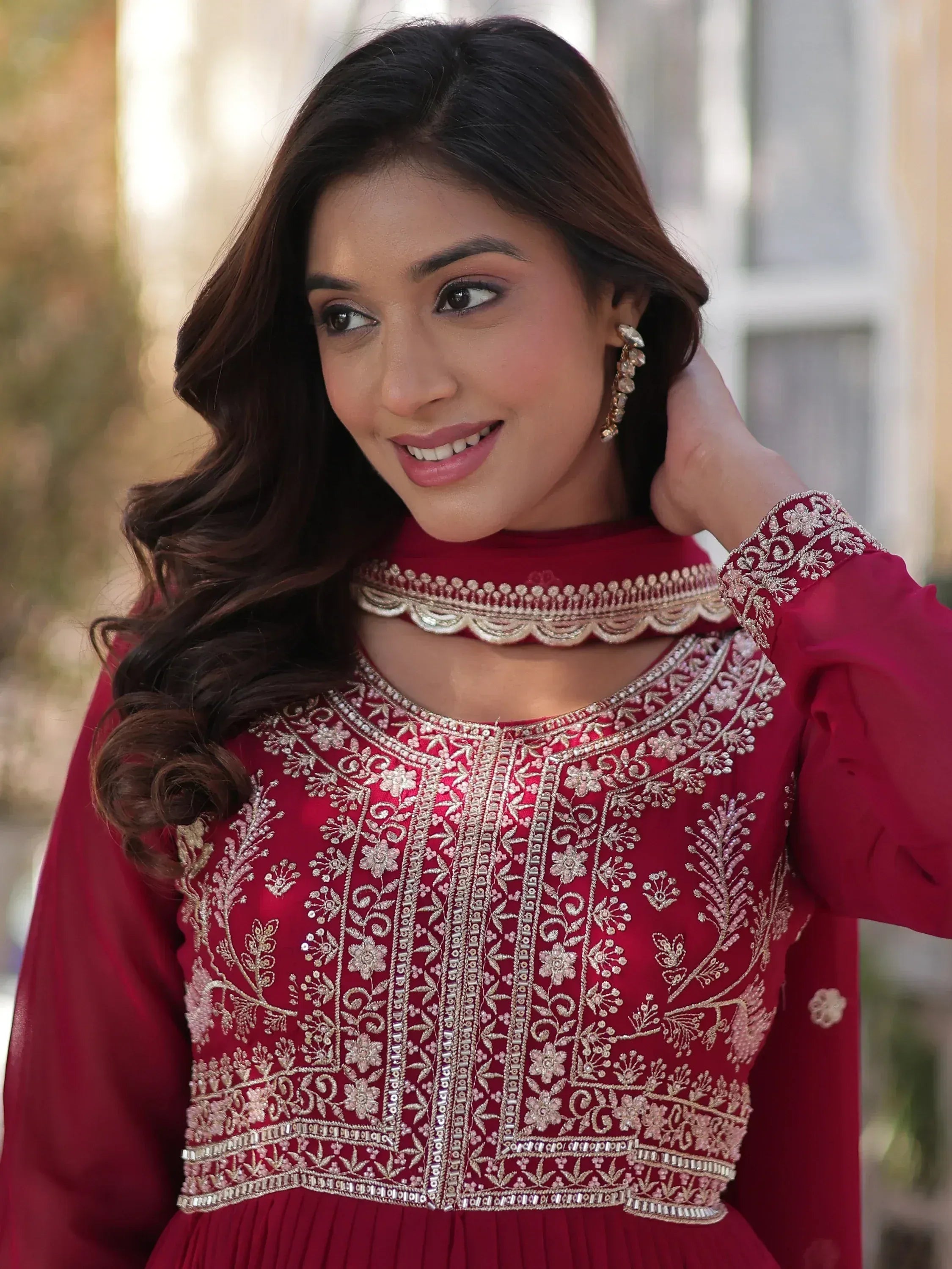 Elegant maroon ethnic gown with intricate gold embroidery and scalloped neckline