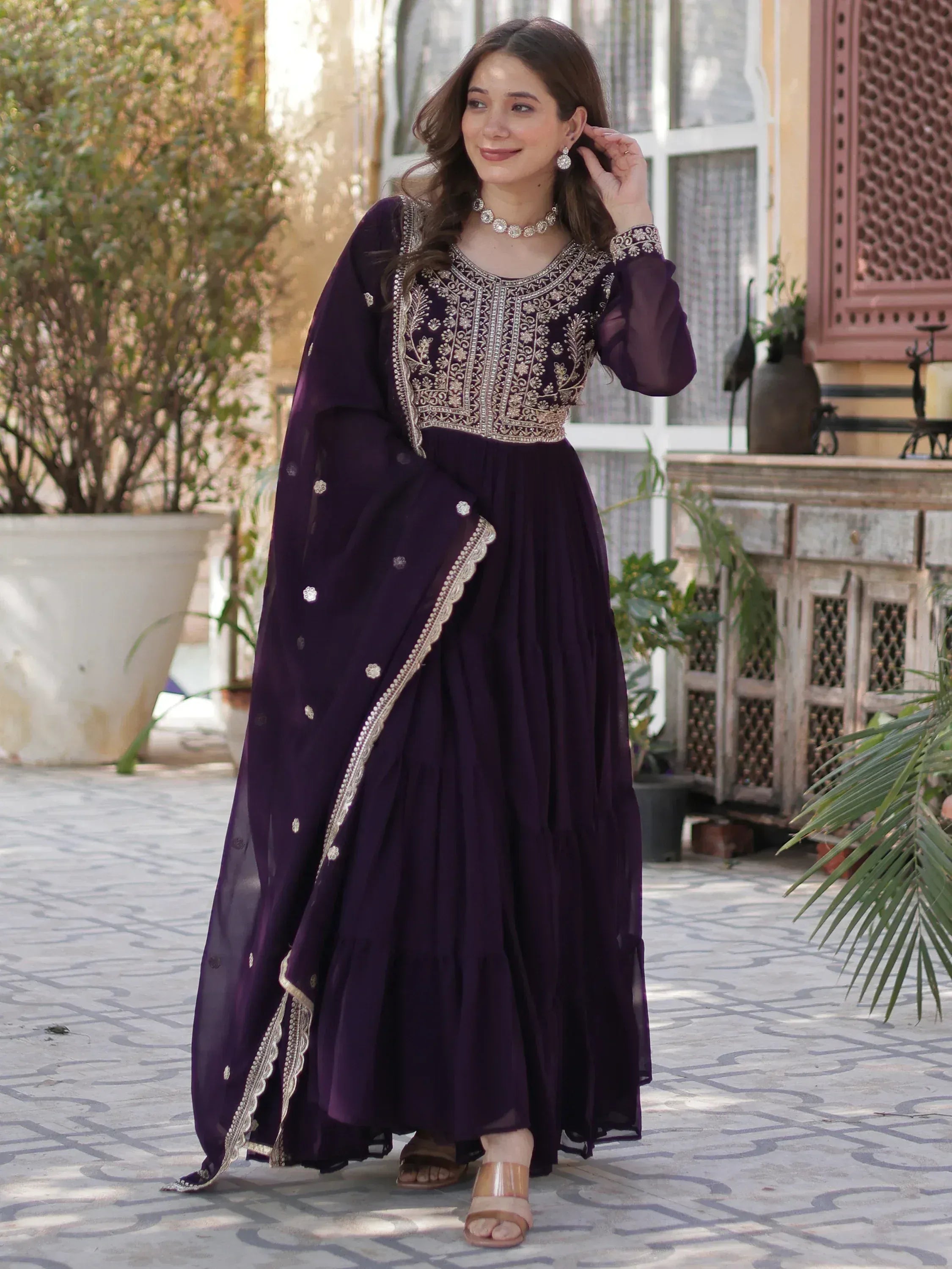Purple ethnic gown with gold embroidery, perfect for Indian occasions and festive wear.