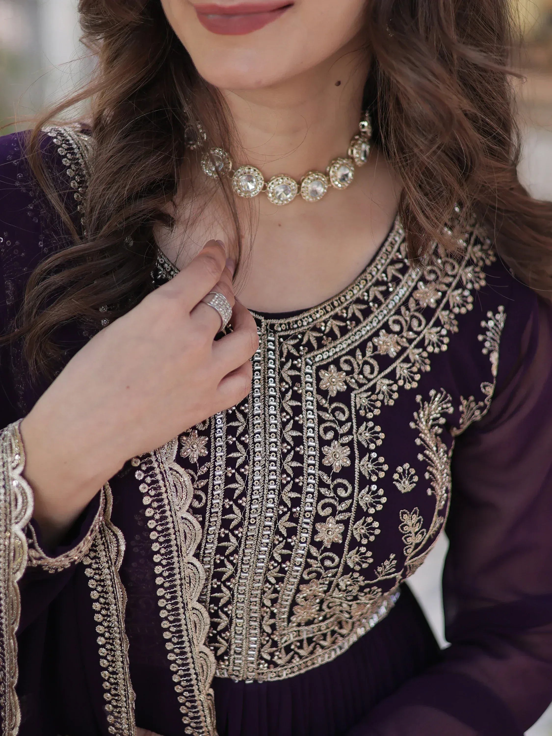 Elegant purple ethnic gown with gold embroidery and matching jewelry
