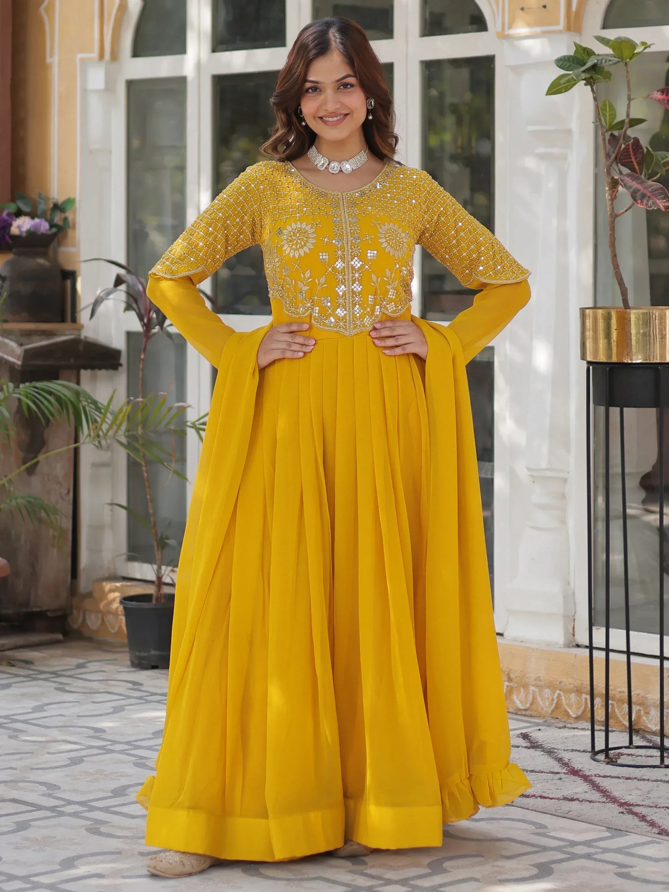 Yellow embroidered anarkali suit with flared skirt, perfect for Indian ethnic wear occasions.